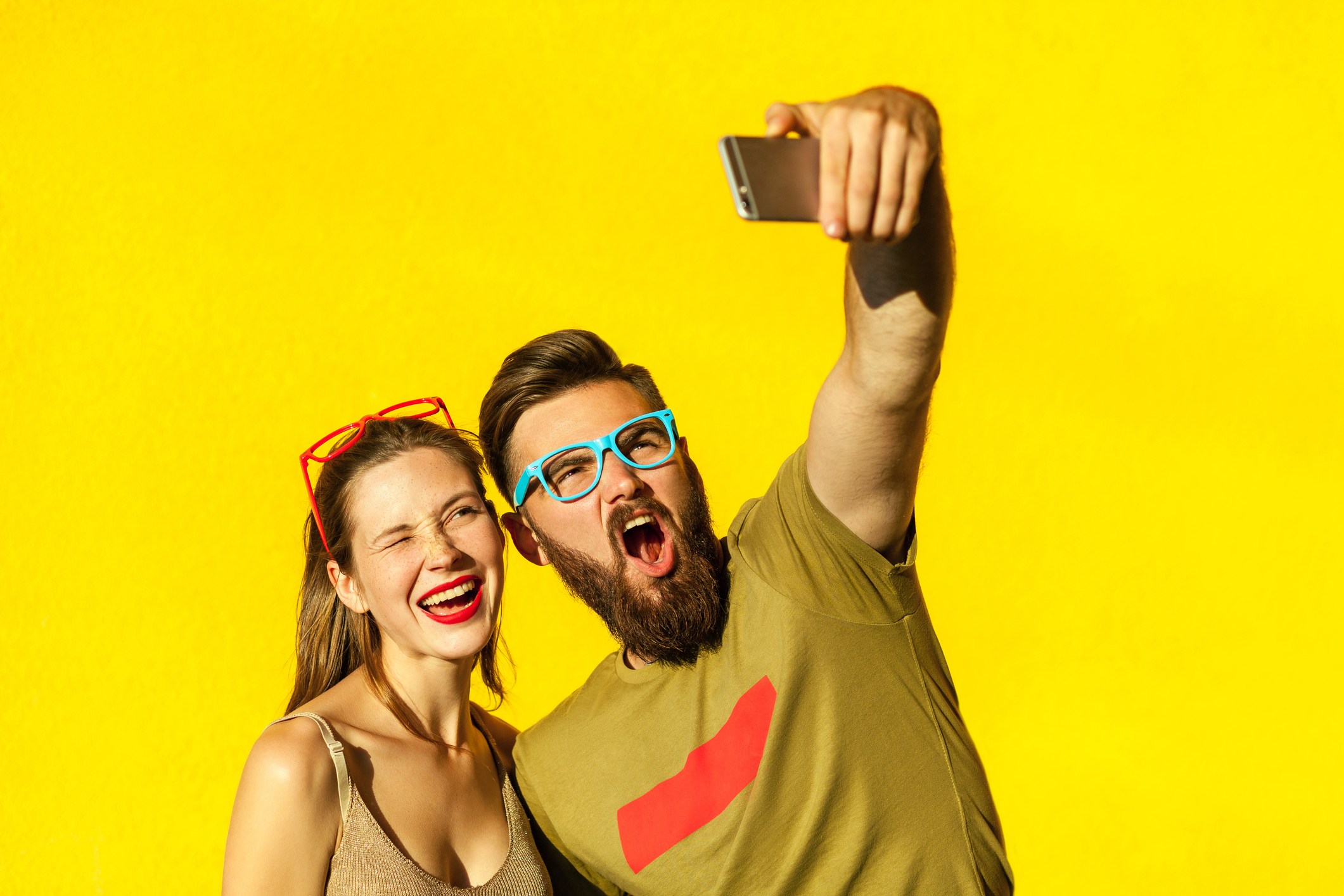 Couple mugging for their smartphone camera