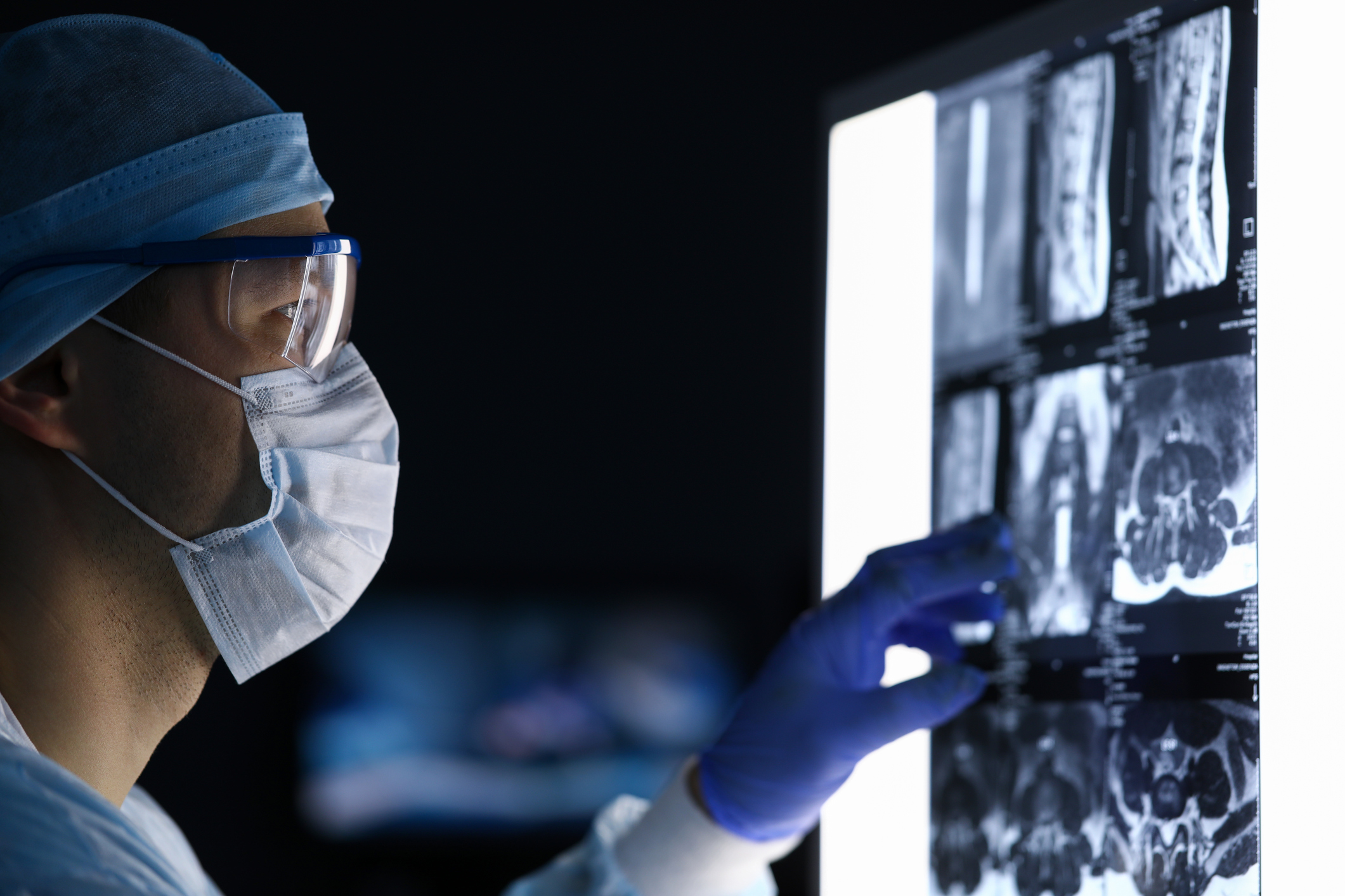 Surgeon looking at medical images while wearing scrubs