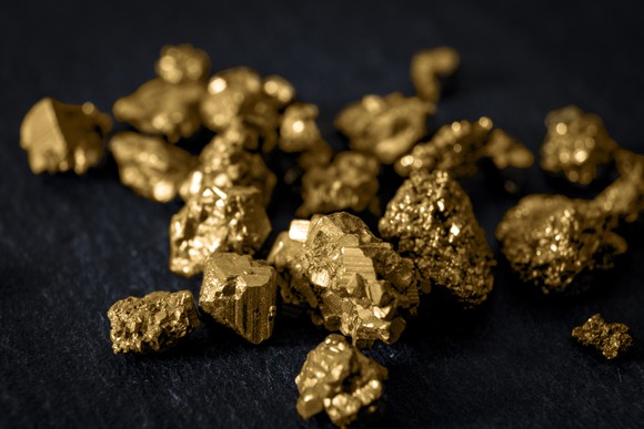 Raw pieces of gold on a black background