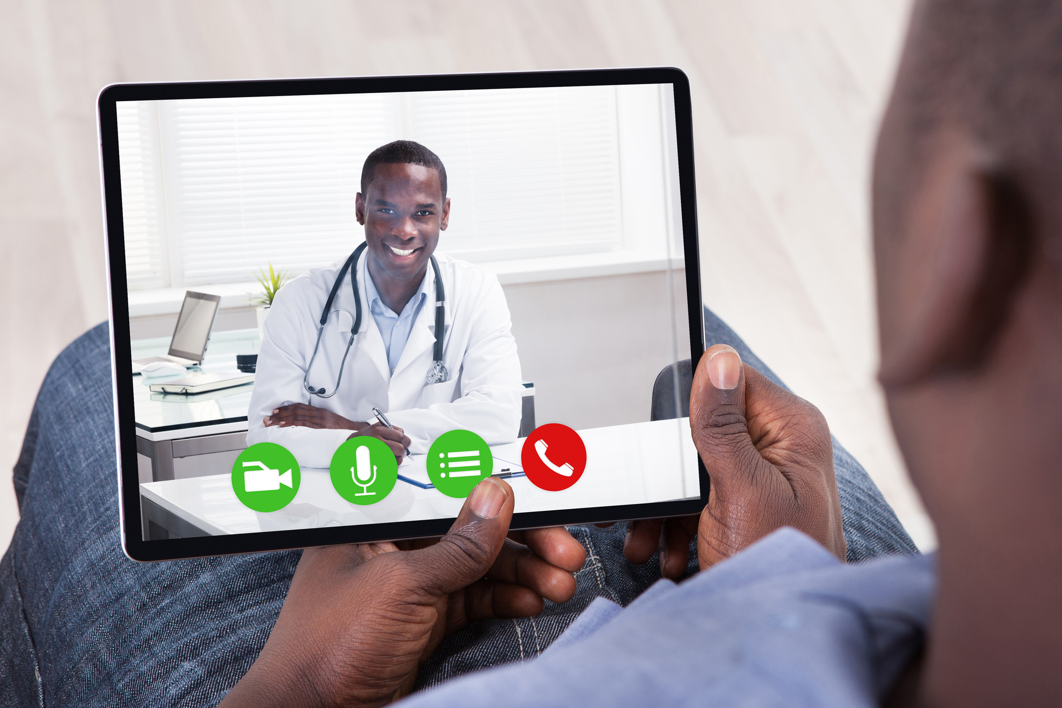 Doctor and patient conferring via tablet.