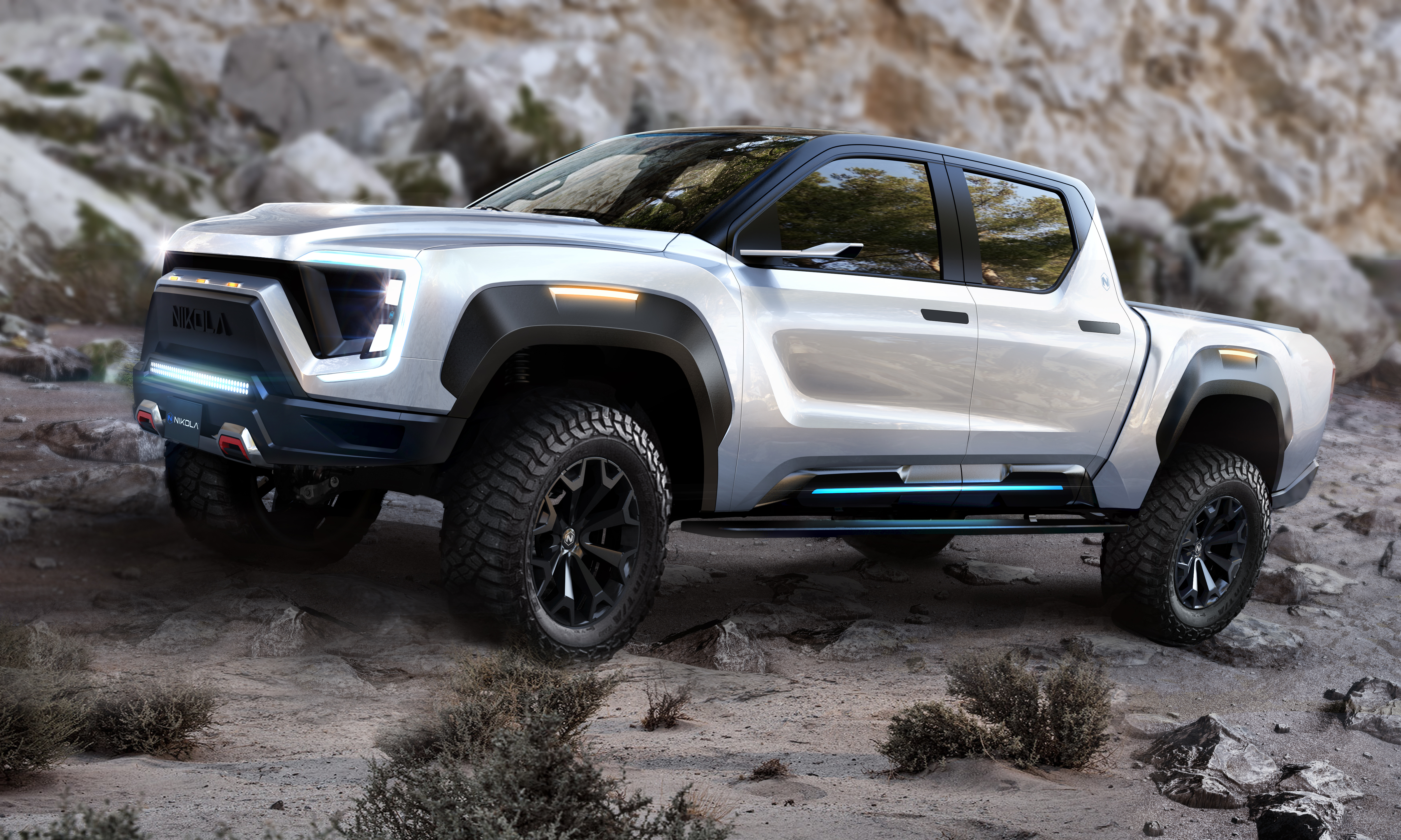 A Nikola Badger electric truck climbing rugged terrain.