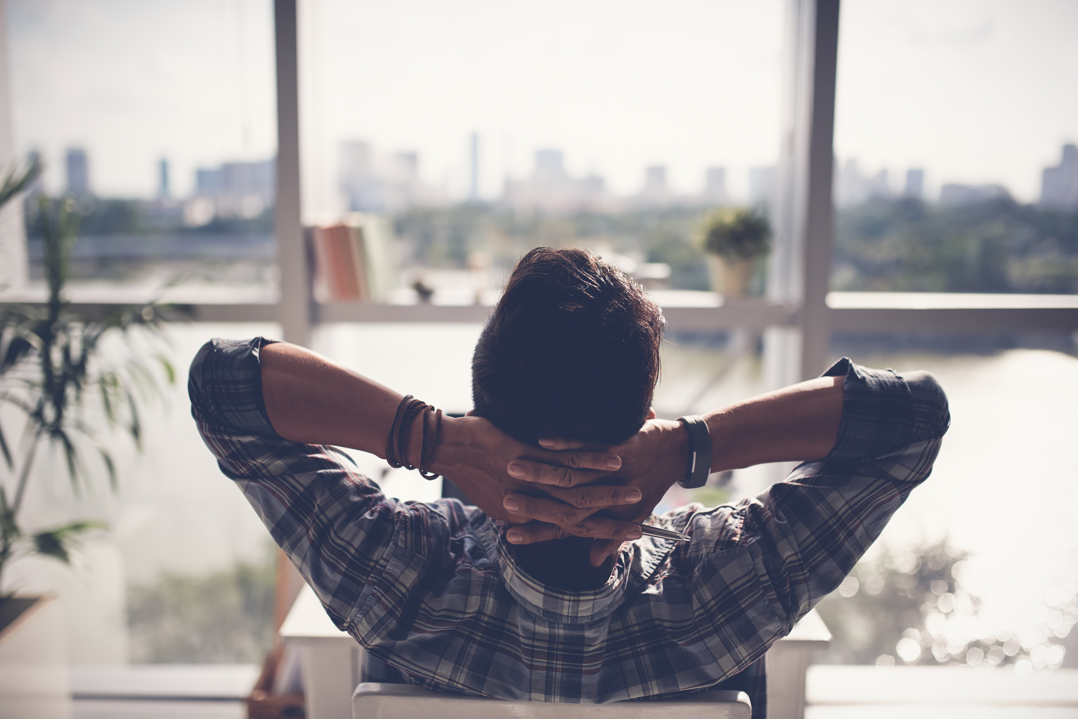 A person relaxing and looking out of window.