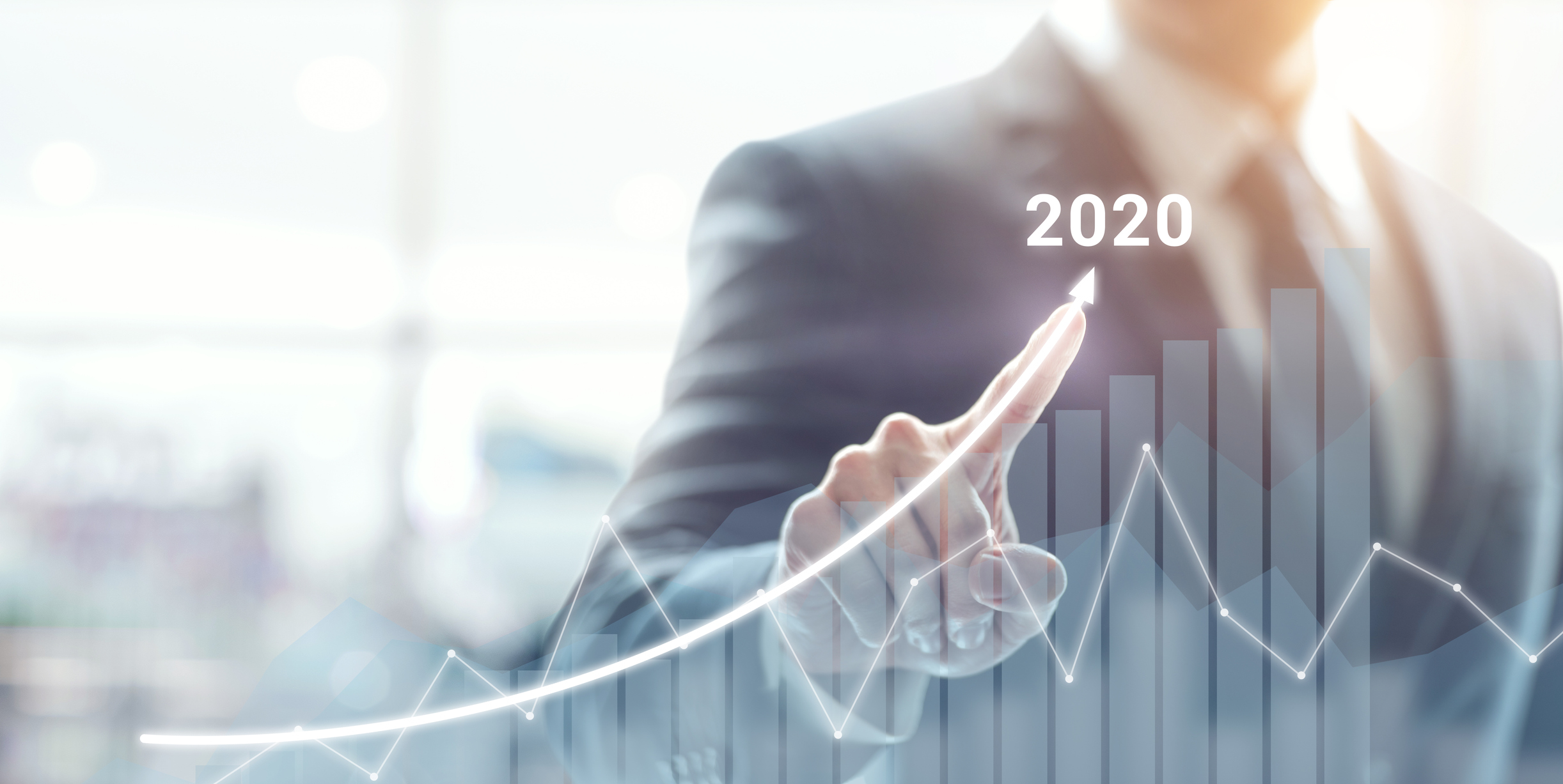 business man drawing digital arrow up with 2020 showing, indicating gains this year