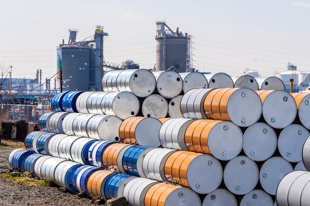 Oil barrels stacked outside of a facility.