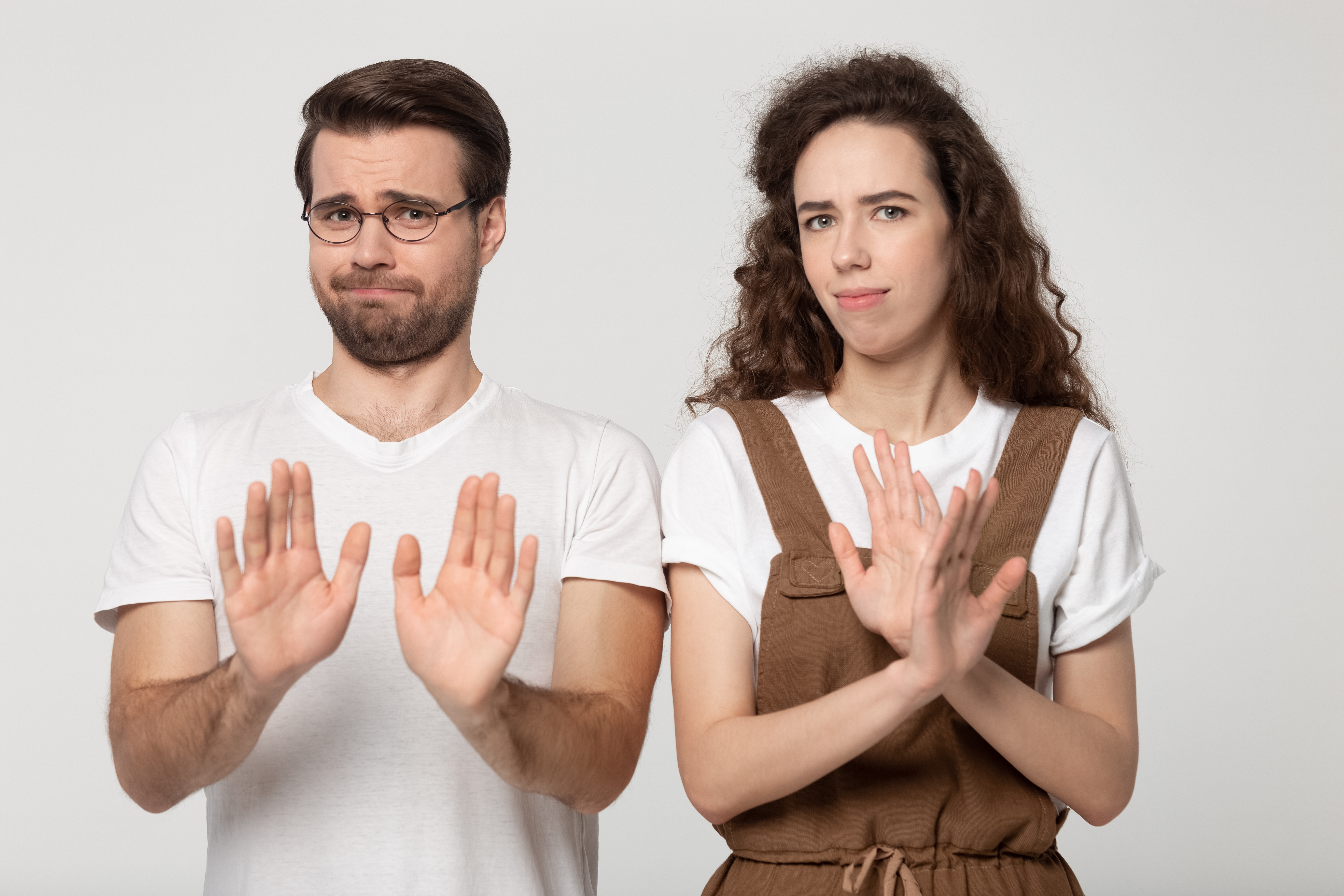 Couple giving refuse gesture.