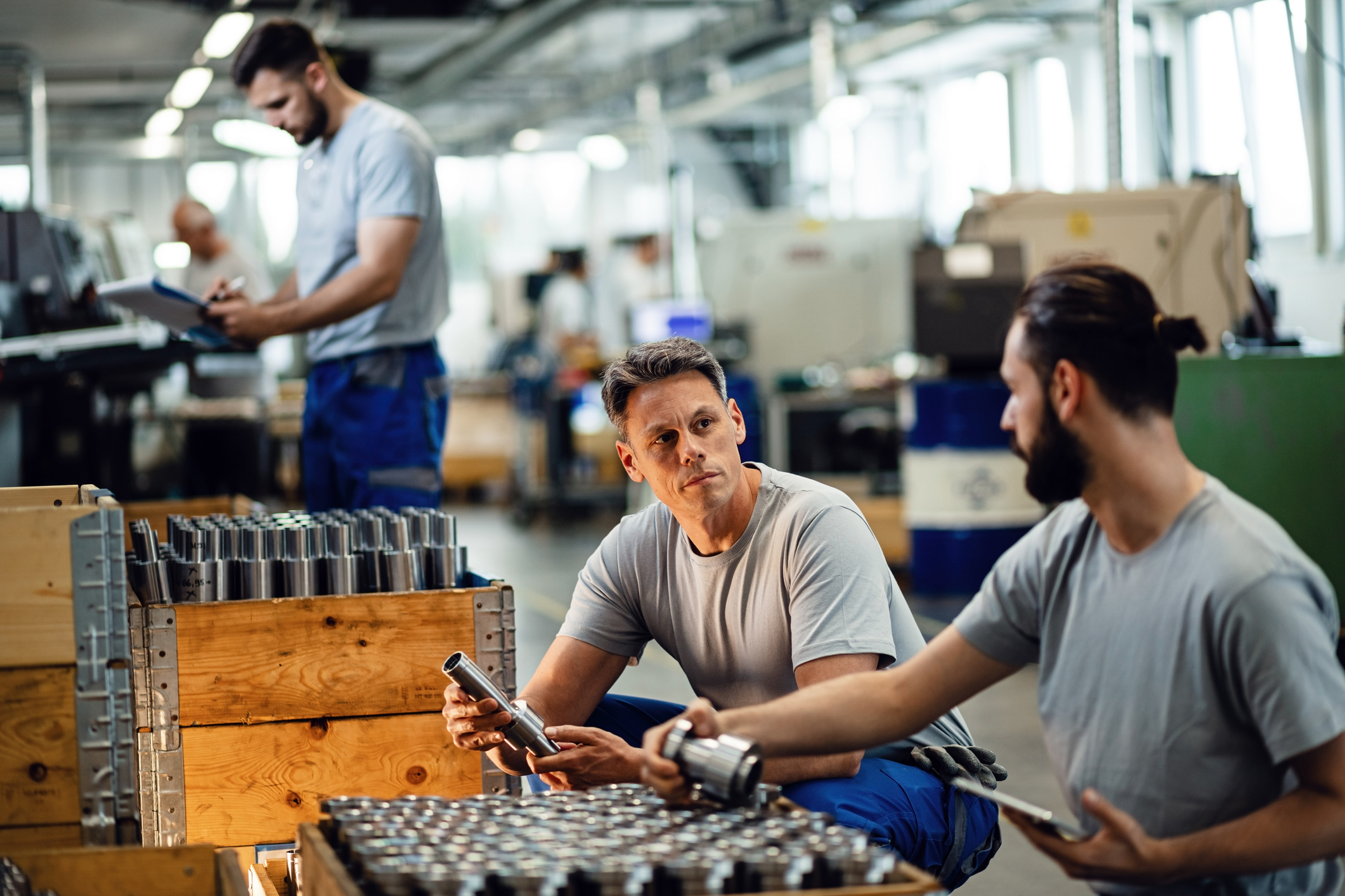Workers with boxes at manufacturing plant