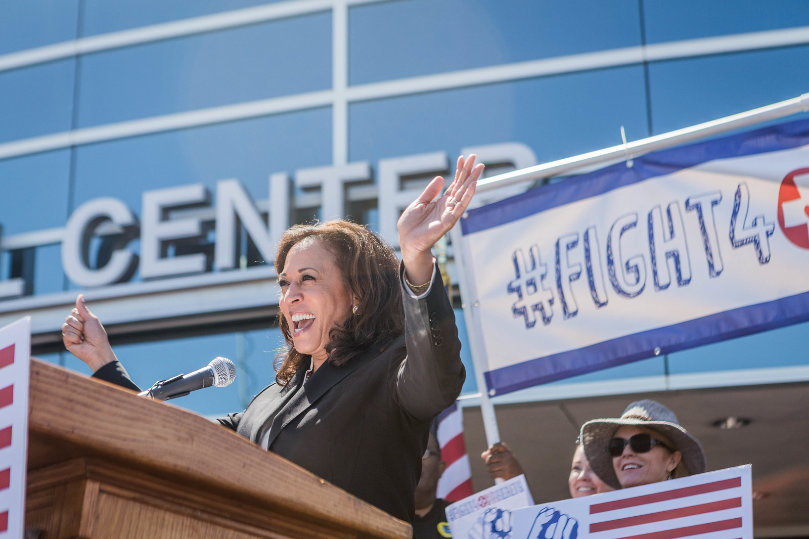 Kamala Harris speaking to a crowd at a healthcare rally.