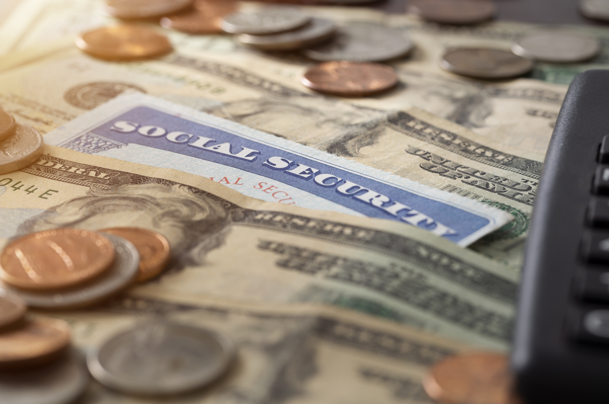 Social Security card with bills and coins