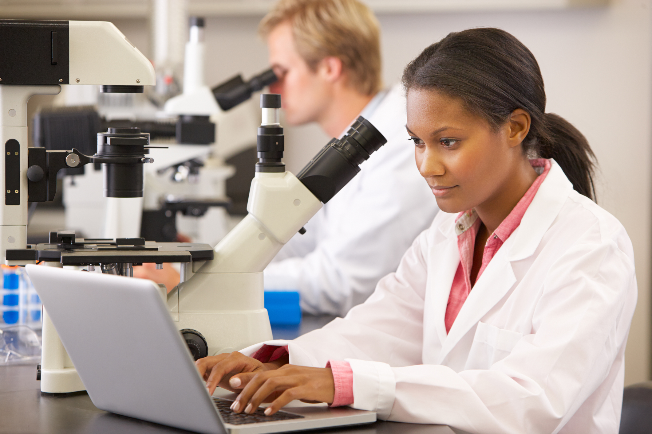 Scientists looking through microscopes