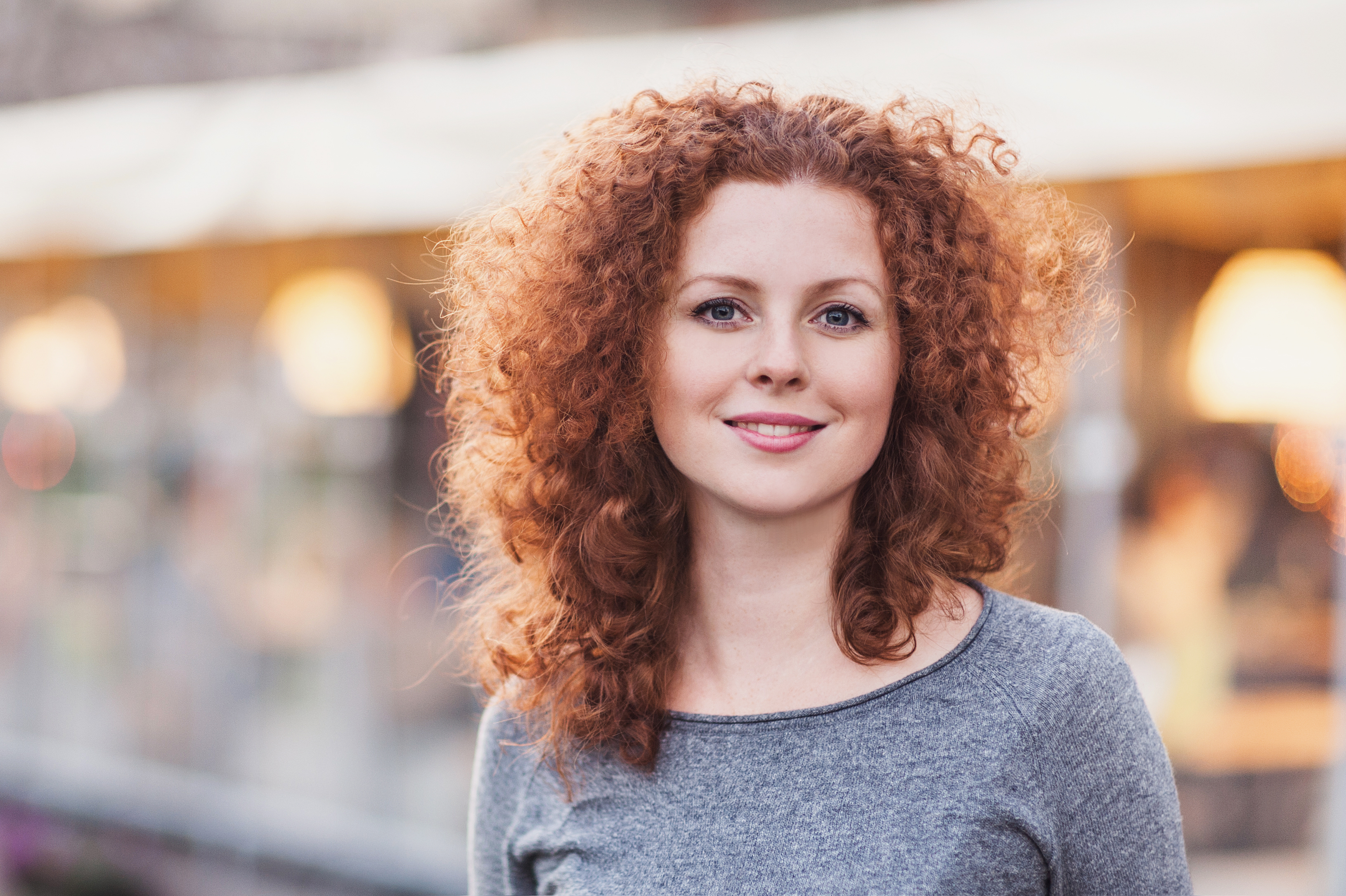 Smiling young woman with curly hair
