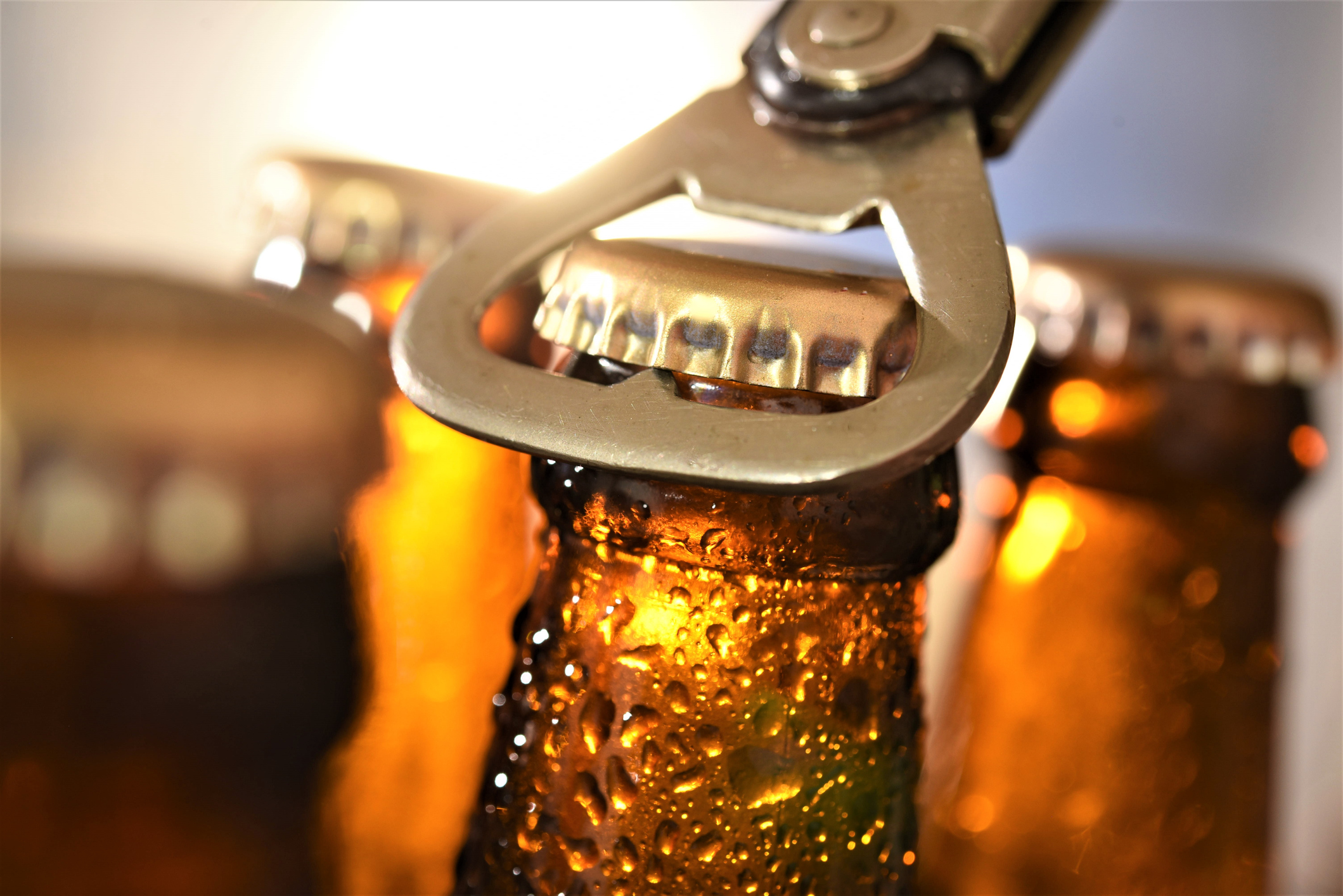 Bottles of beer being opened.