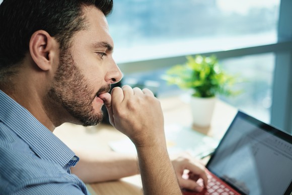 Anxious businessperson looking at their computer.