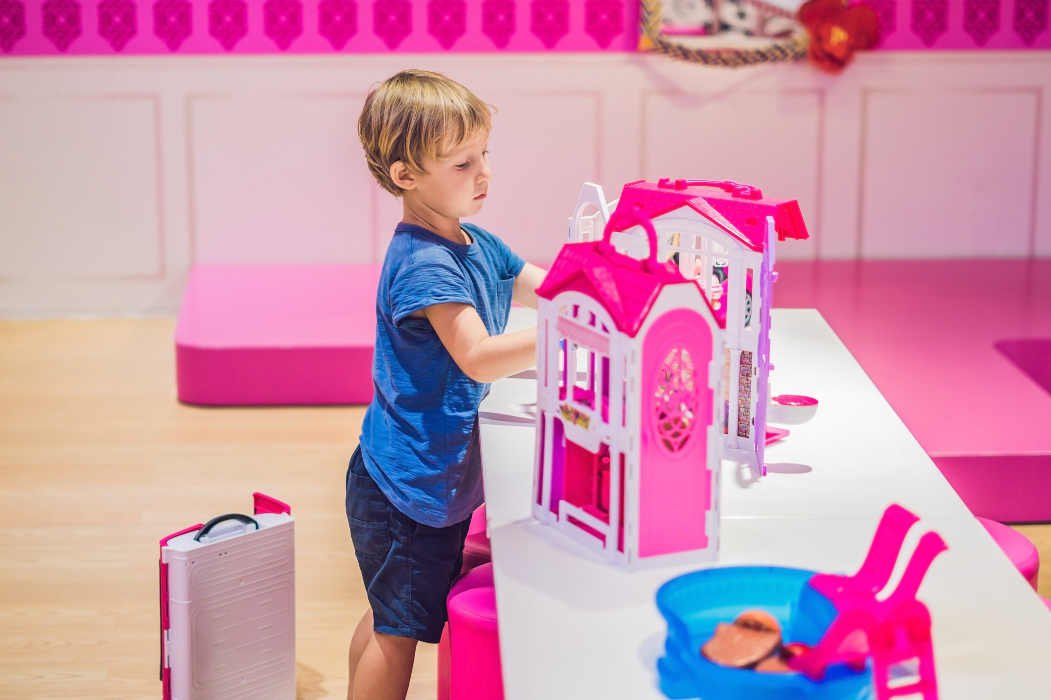 Child playing with toy house.