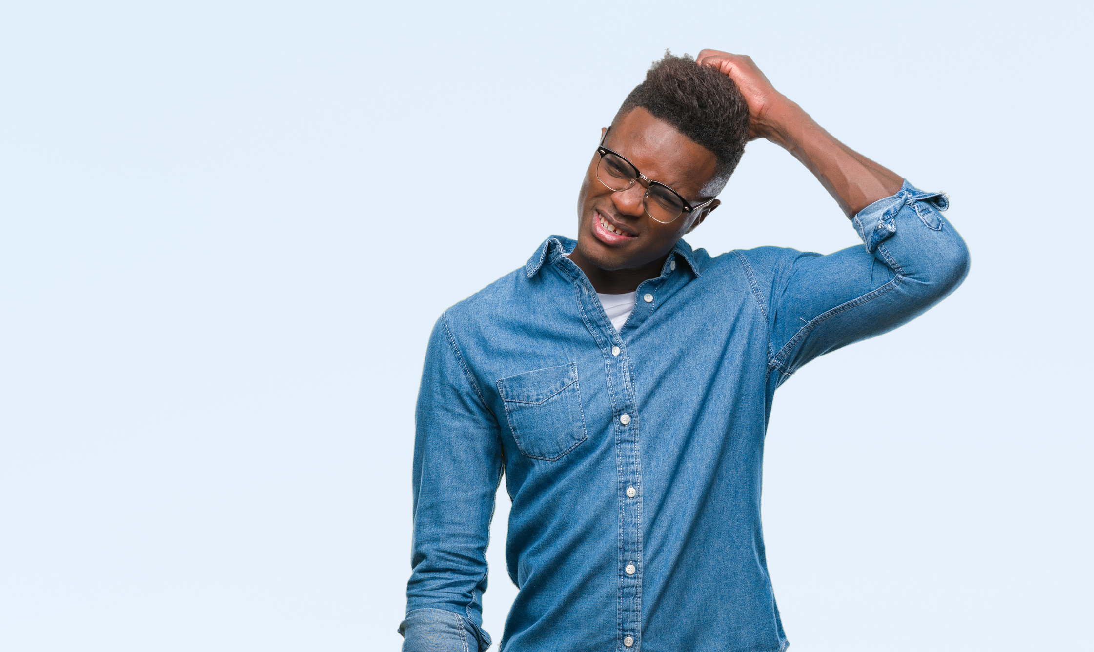 Young person scratching their head and wearing a perplexed expression.