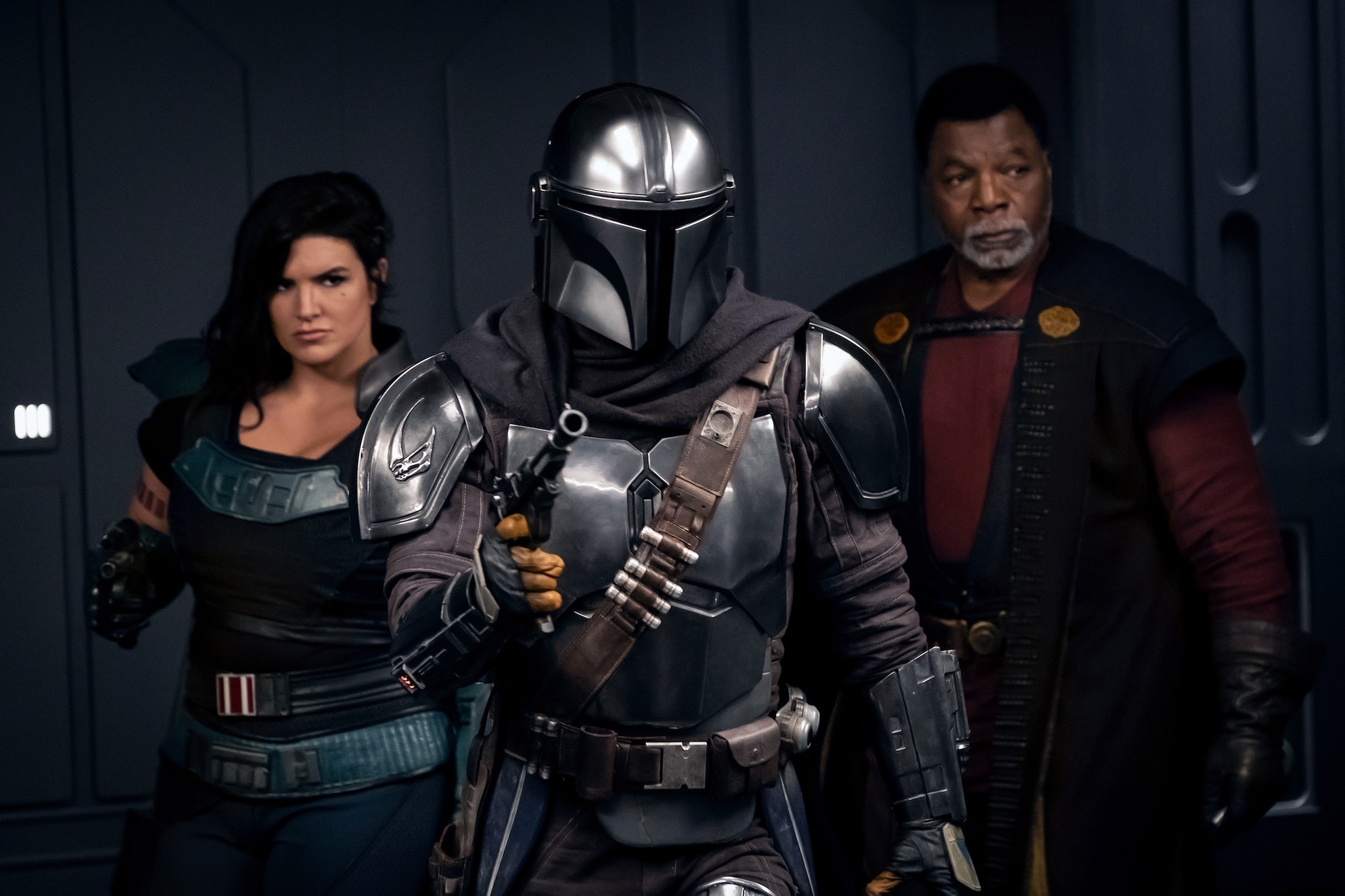 Three heavily armed people facing an unknown foe.