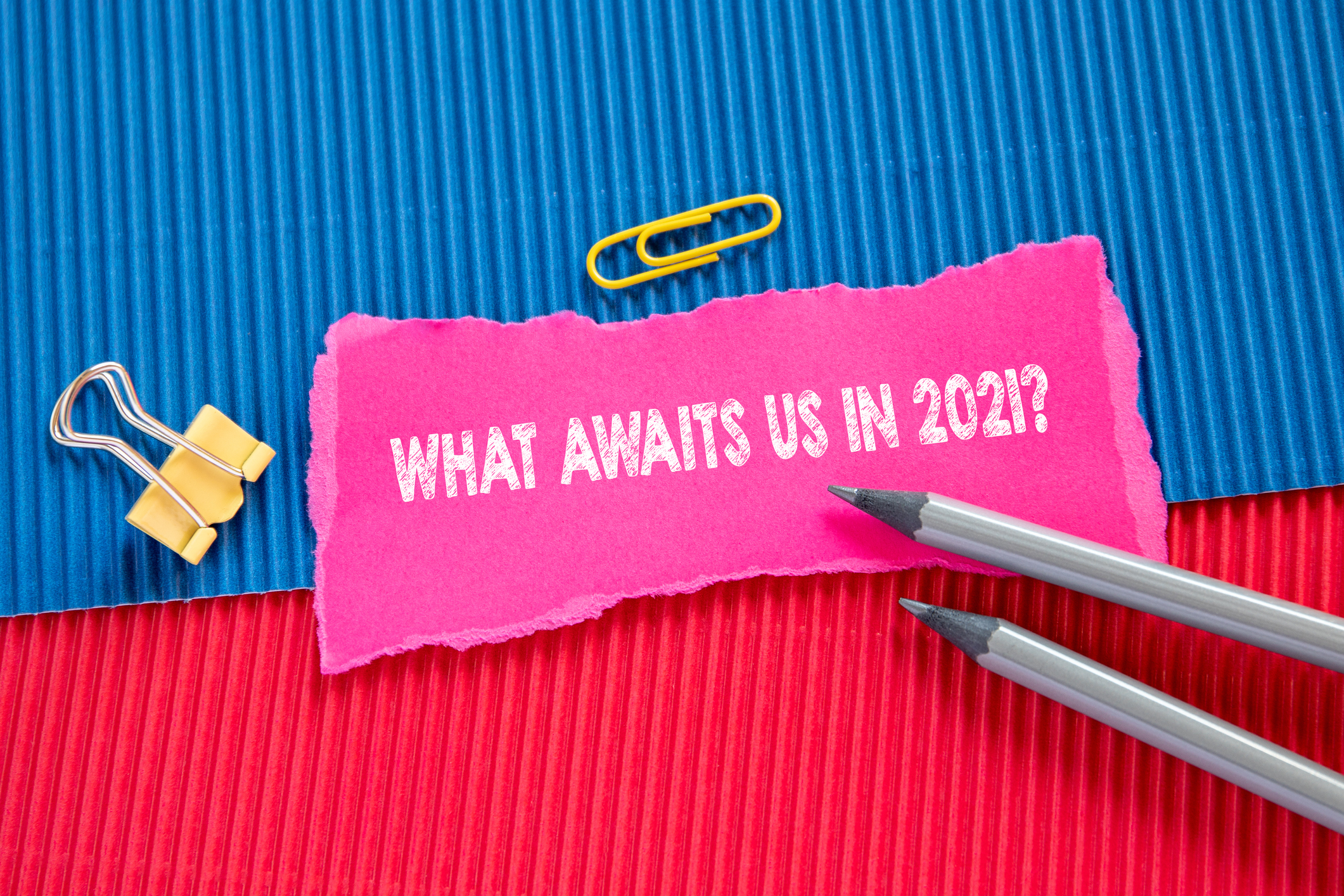 what awaits us in 2021? sign sitting on red and blue paper
