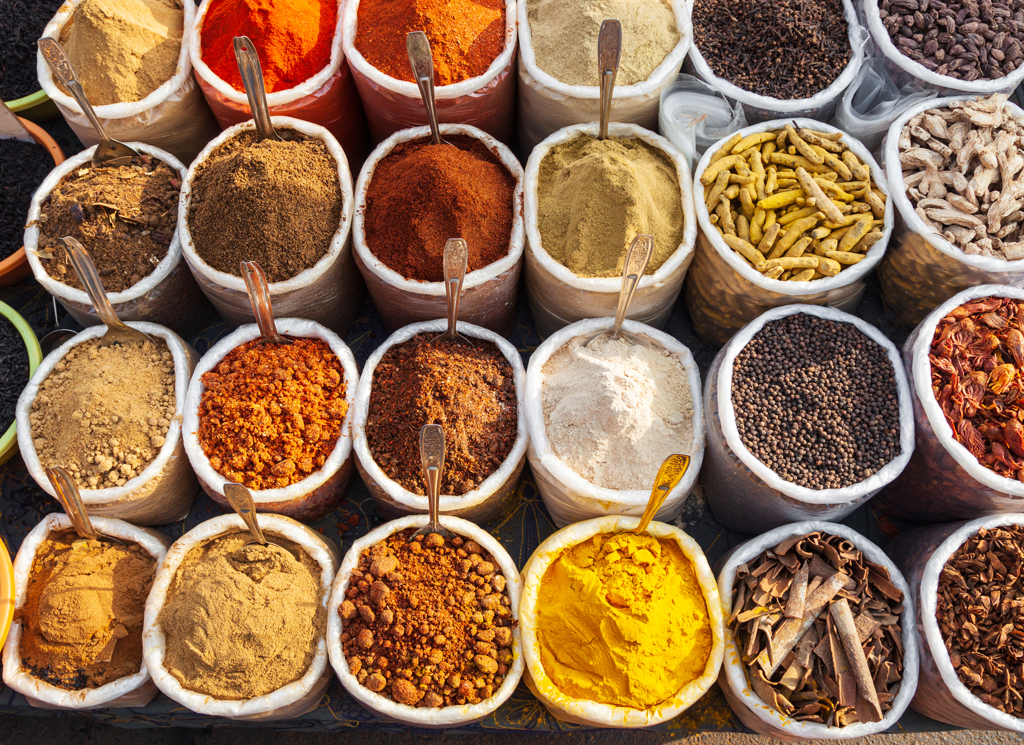 Overhead view of a variety of dry spices in bowls