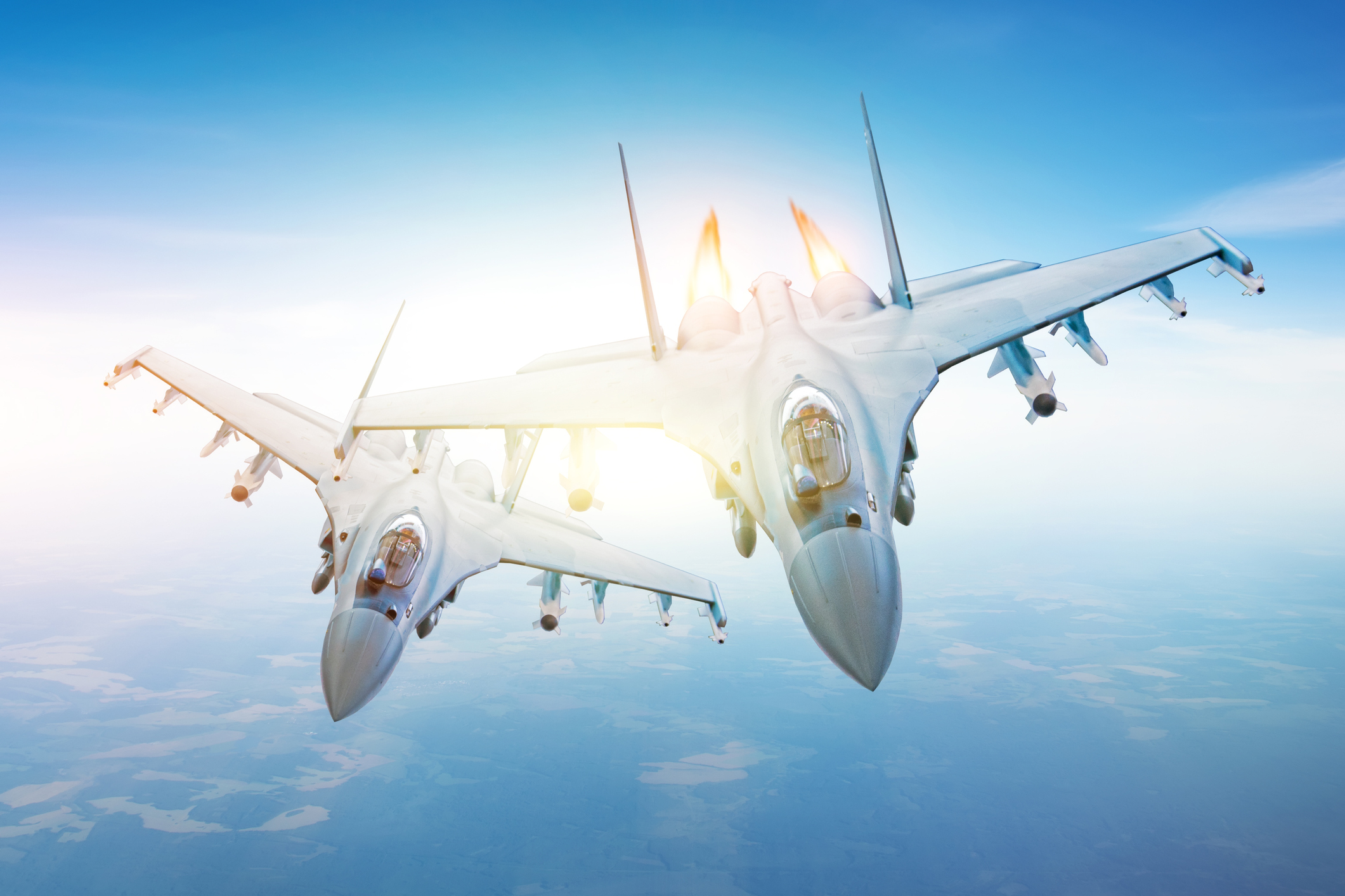 Two fighter jets flying near each other.