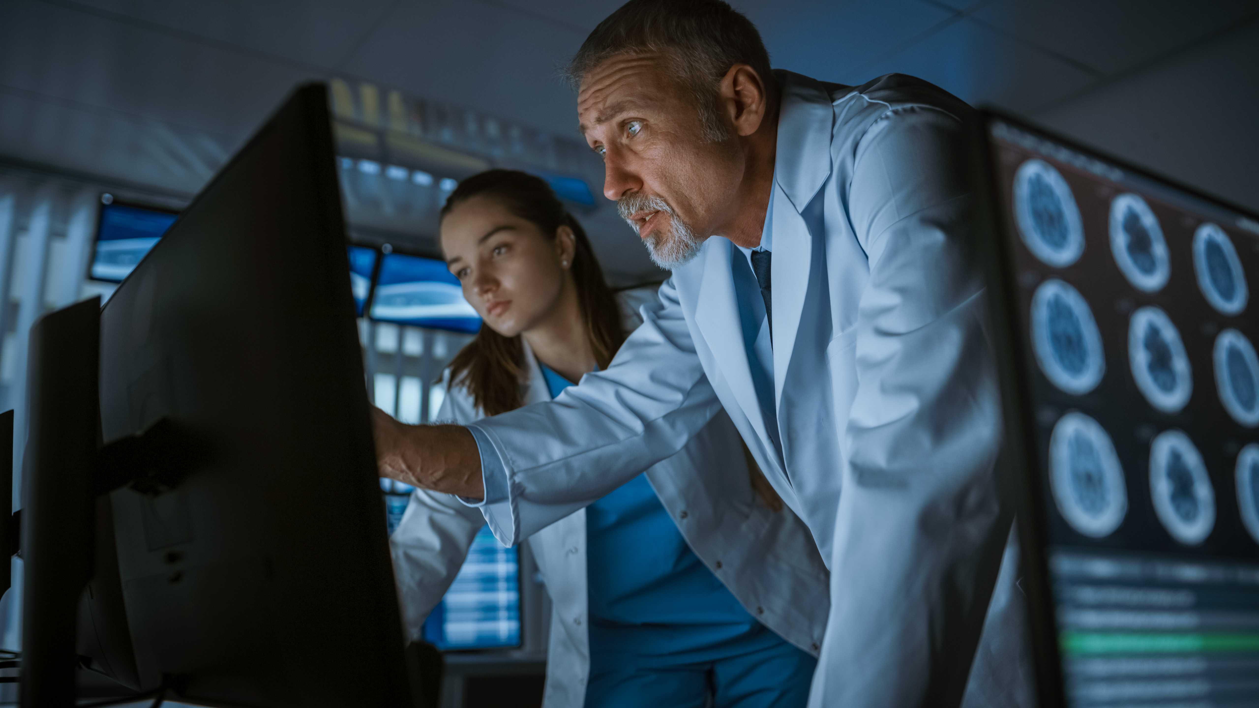 Two neuroscientists studying a brain scan.