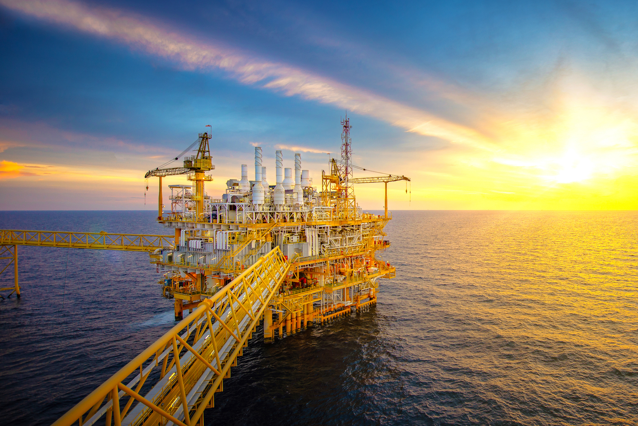 A crude oil rig and supply vessel in the Gulf of Mexico.