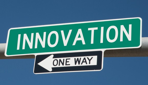 A street sign that says "INNOVATION" above a one-way street sign. 