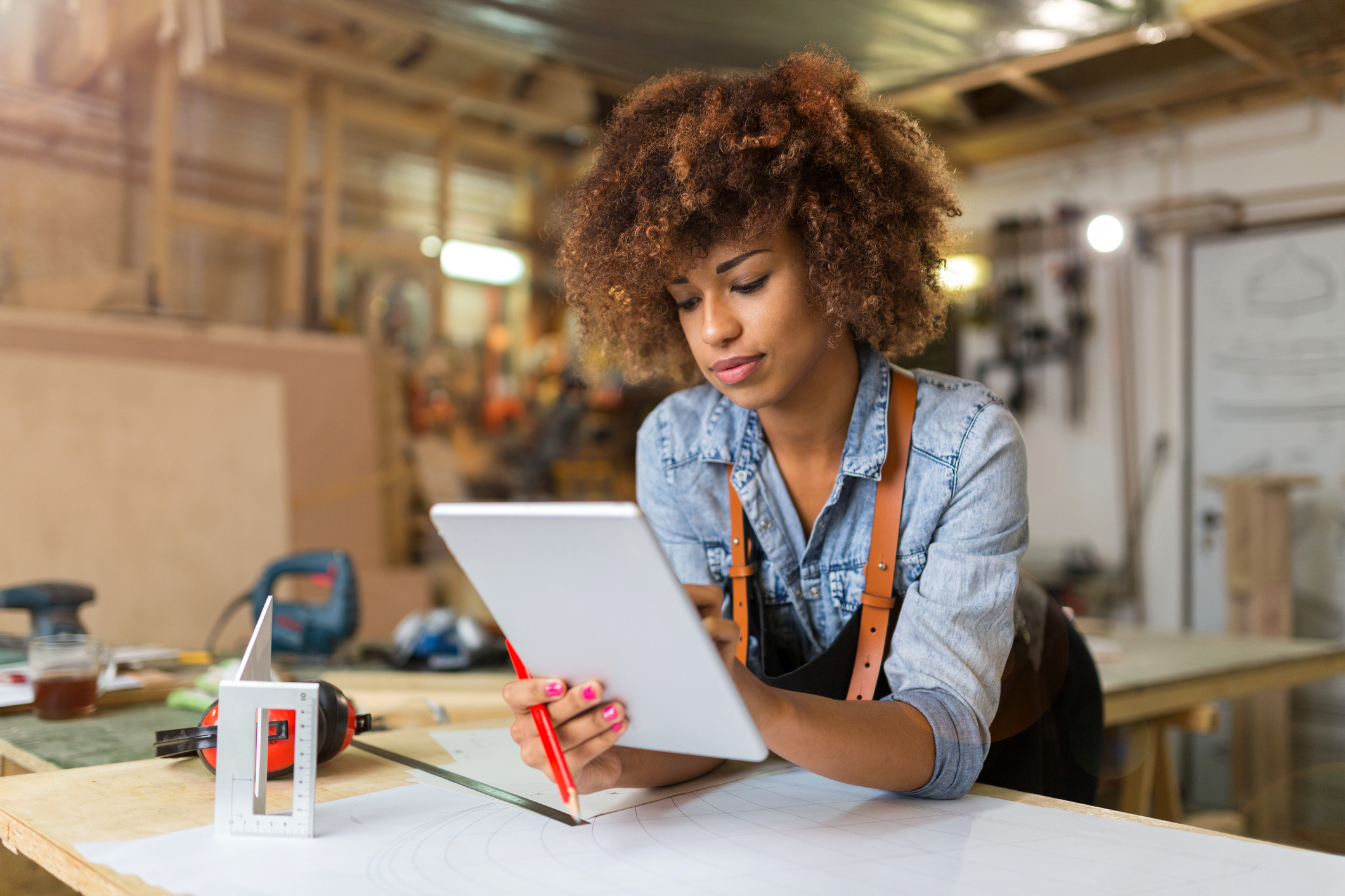 Small business owner with a computer in a shop.