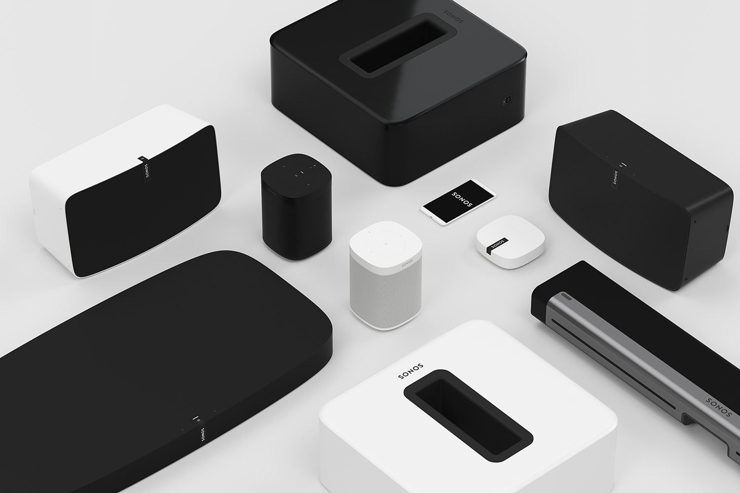 Several types of Sonos speakers and a mobile device running the Sonos app