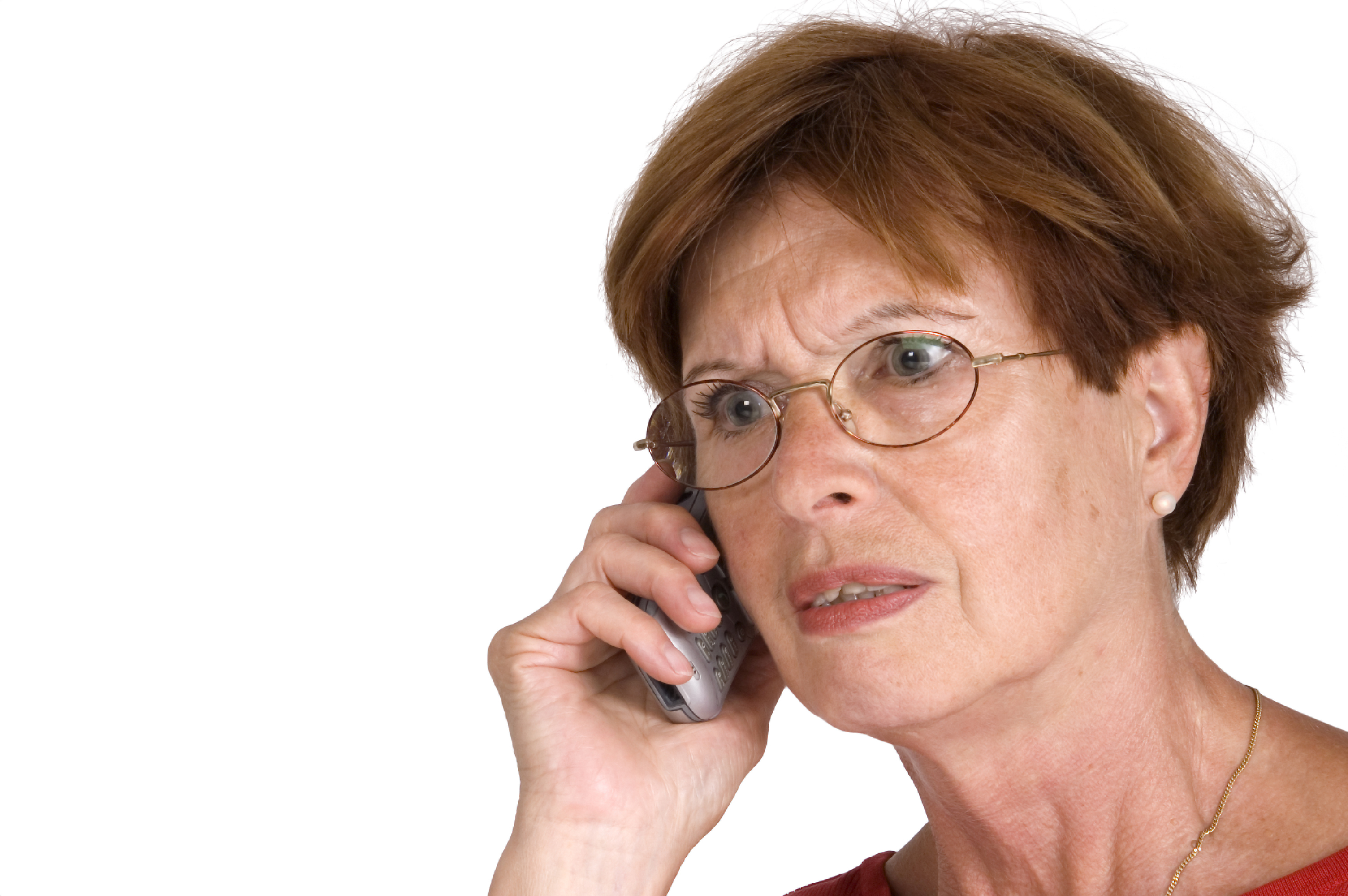 Older person with a distressed expression holding phone to ear.