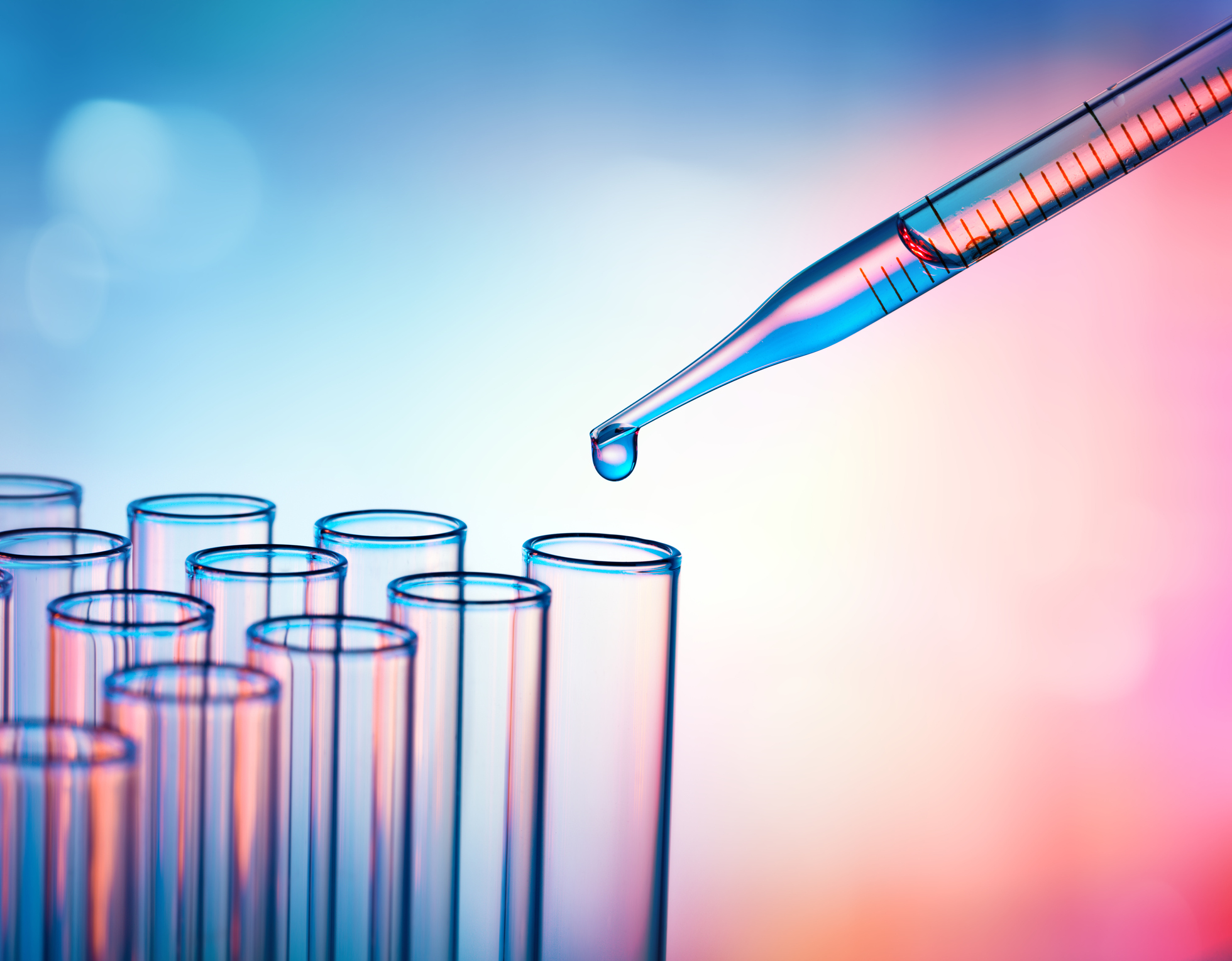 Pipette poised over rows of test tubes.