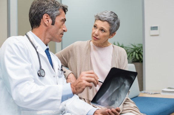 Doctor showing scan to older woman