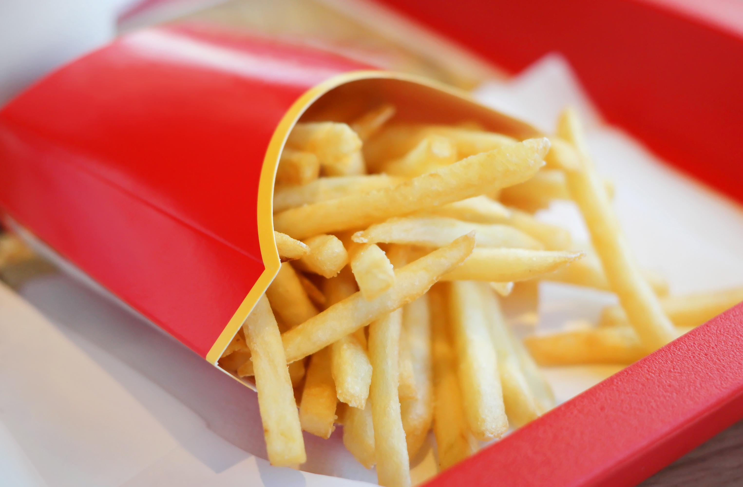 Fast-food french fries in a red carton.