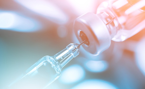 Vaccine bottle with syringe and needle