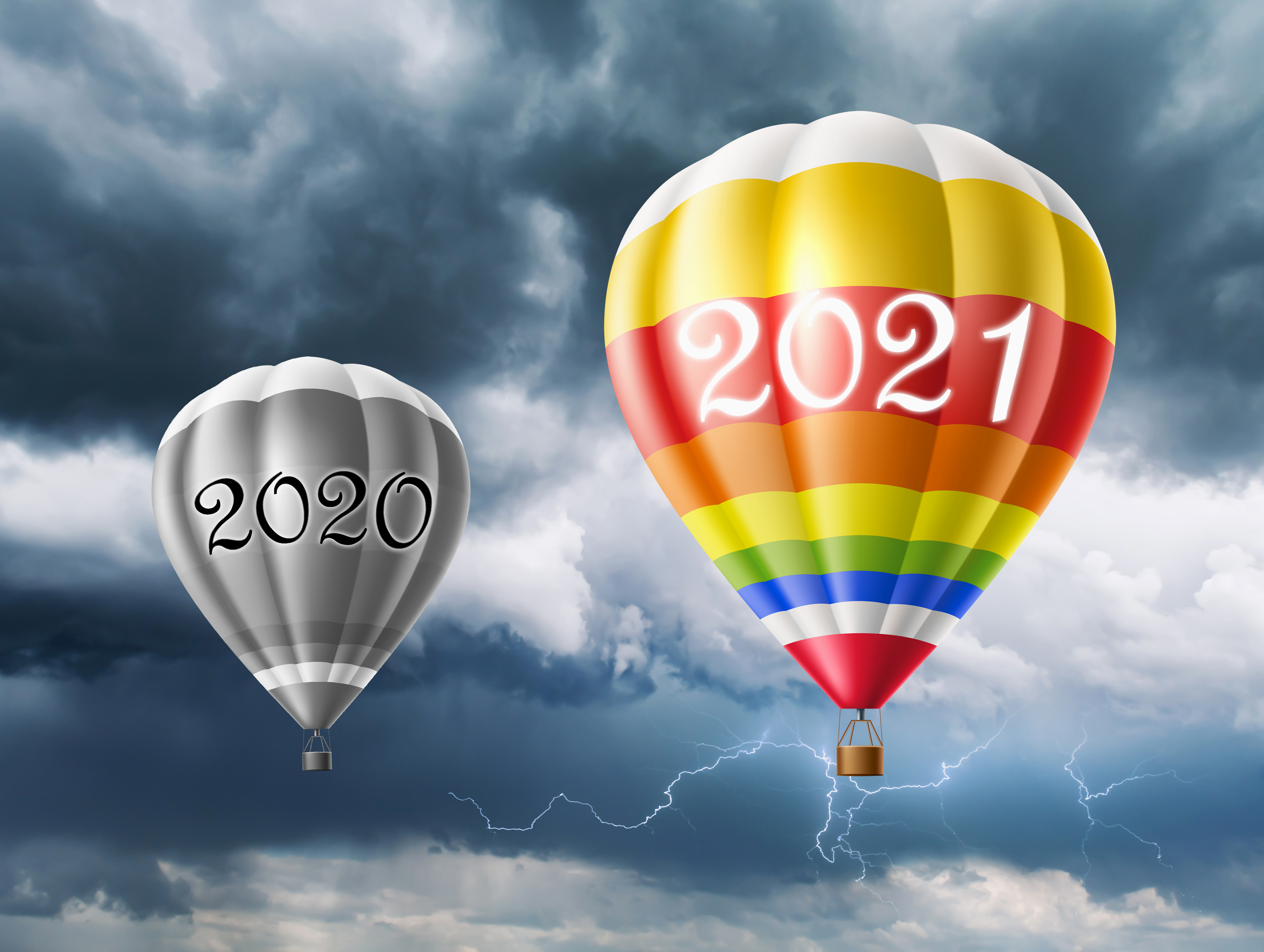 grey 2020 hot air balloon with colorful 2021 balloon ahead of it