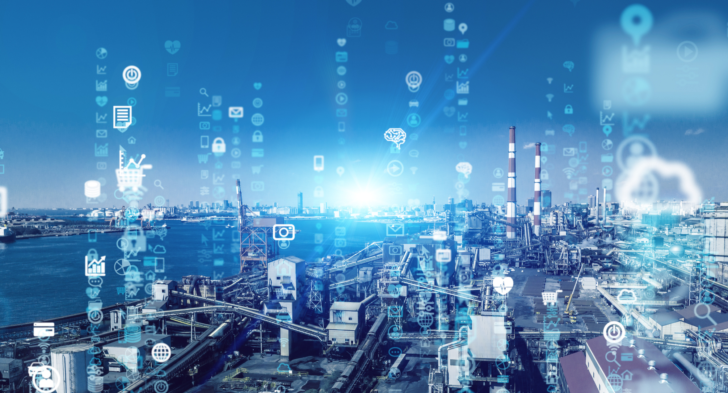 An industrial plant with digital icons floating above it.