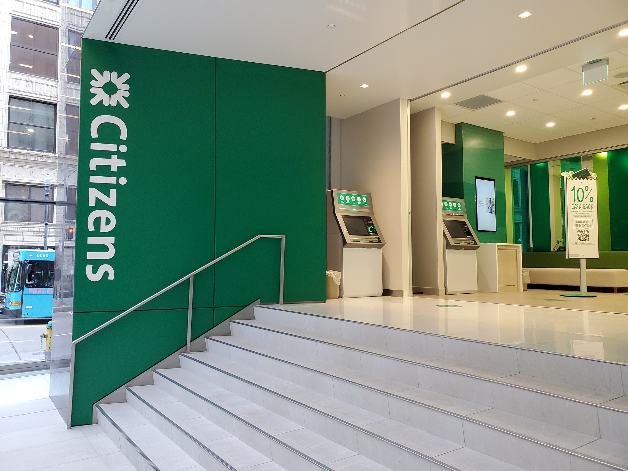 The interior of a Citizens Bank with a flight of stairs leading to the main floor.