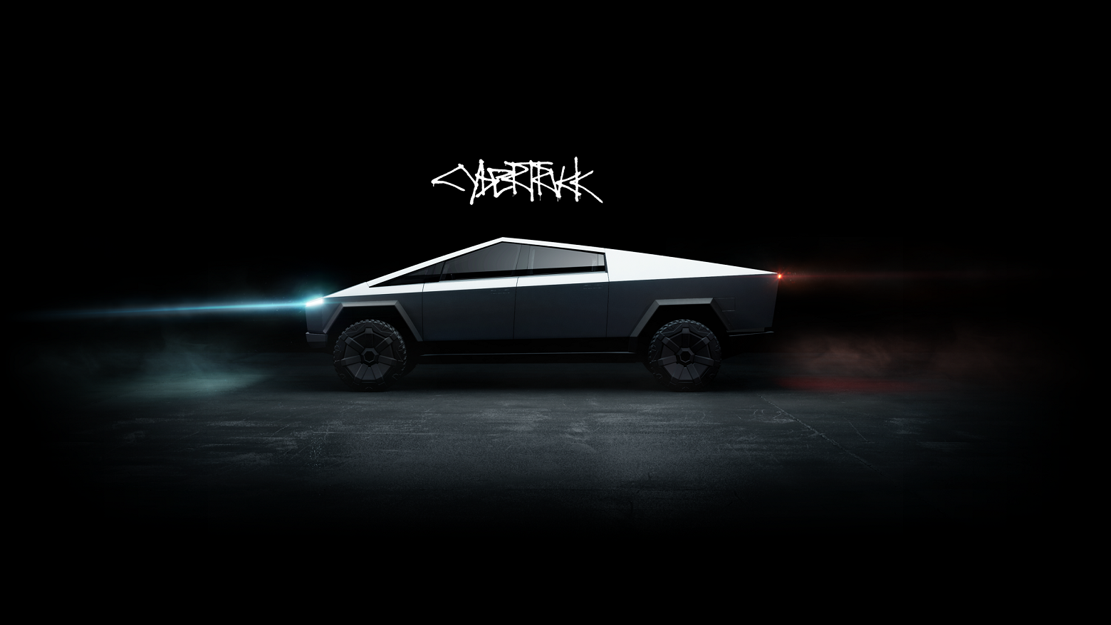 Silver Tesla Cybertruck, in low light in a dark room.