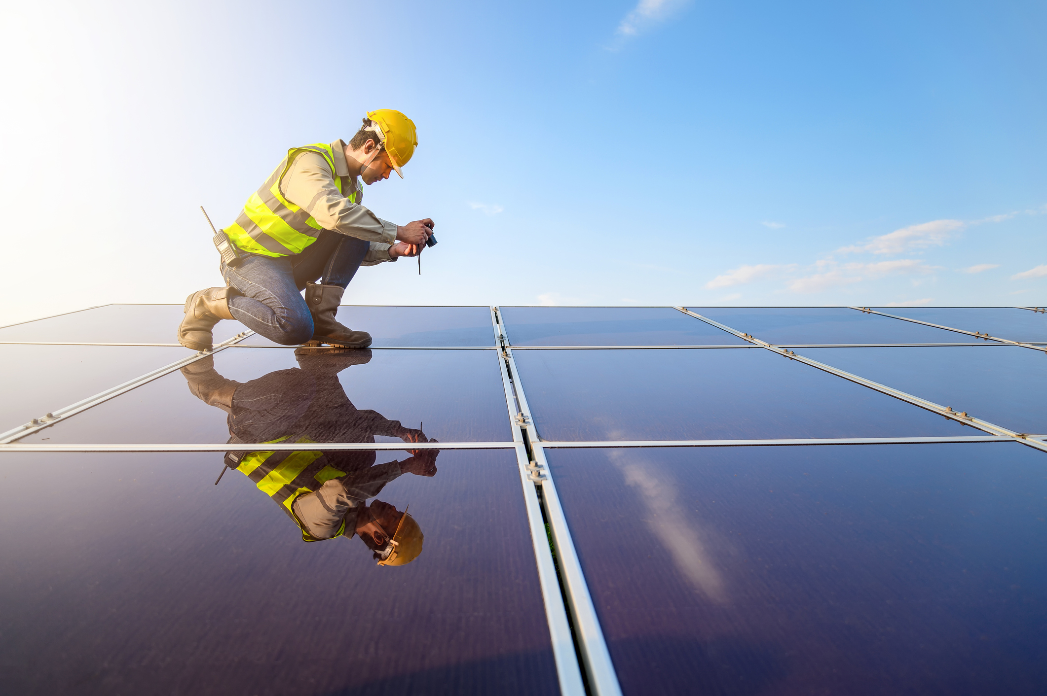 Solar engineer checking numerous panels.