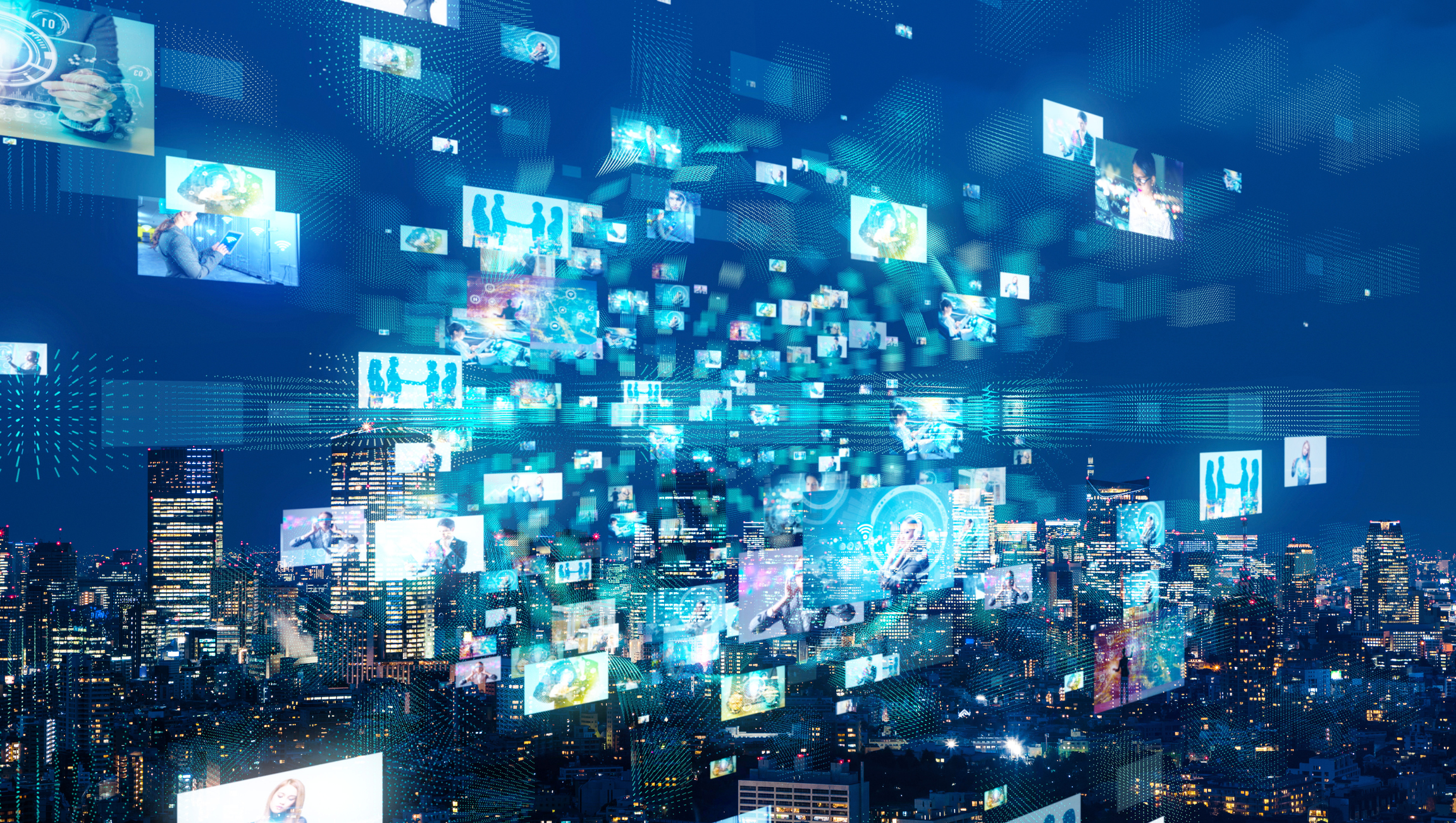 TV screens superimposed over a city skyline at night.