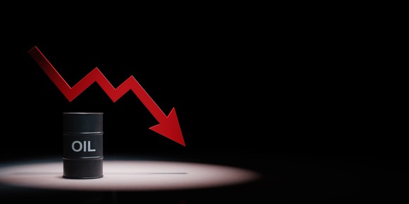 Barrel of oil with declining chart illustrated behind it. 