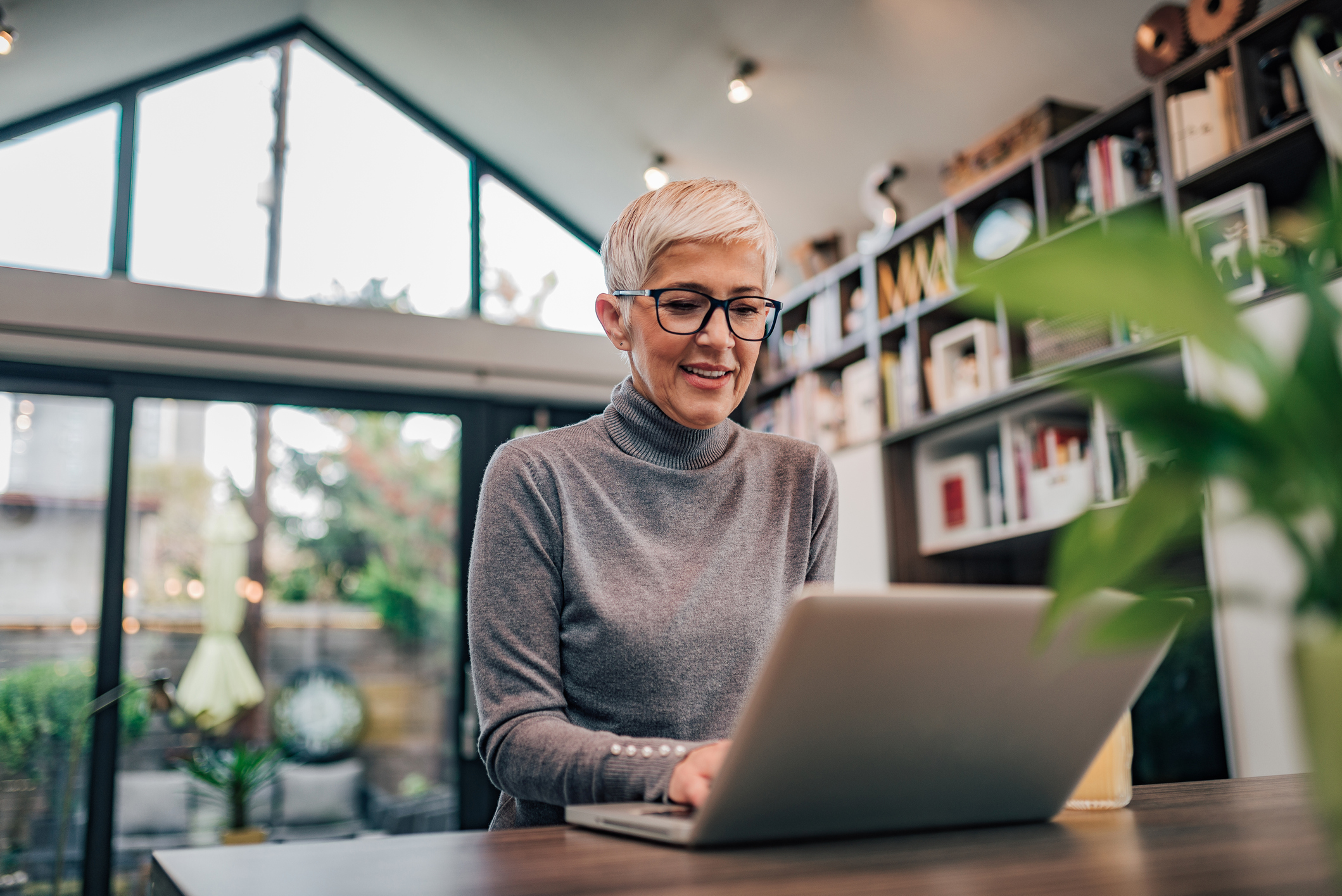 Older woman typing on laptop