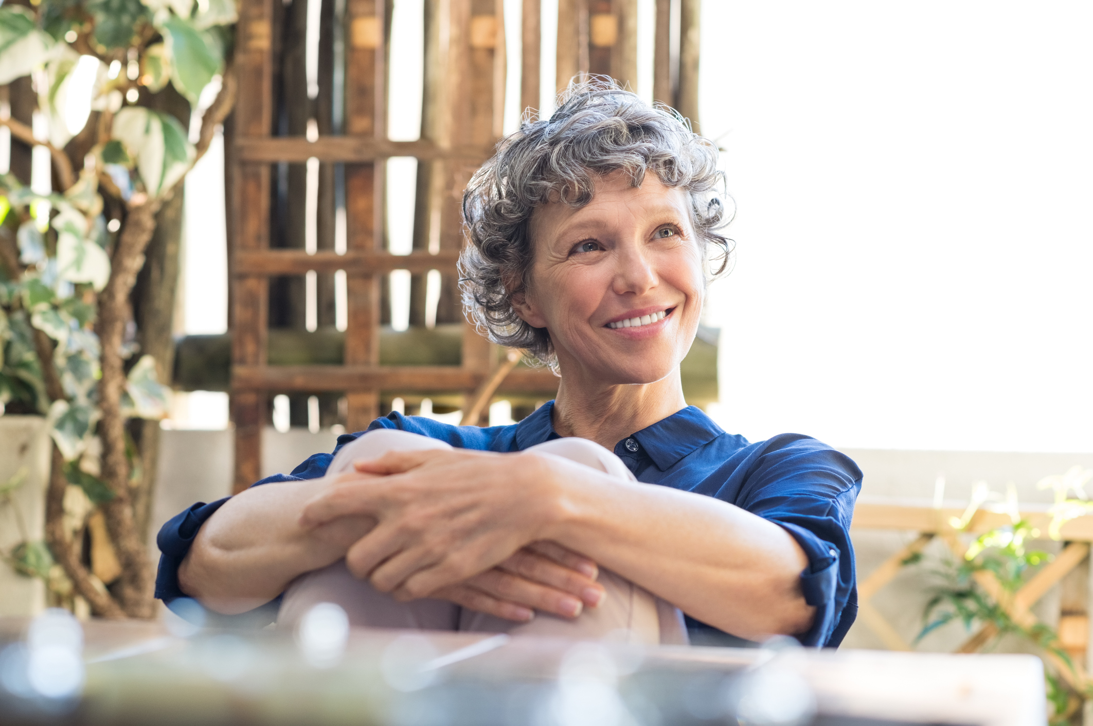Smiling older person sitting outdoors.