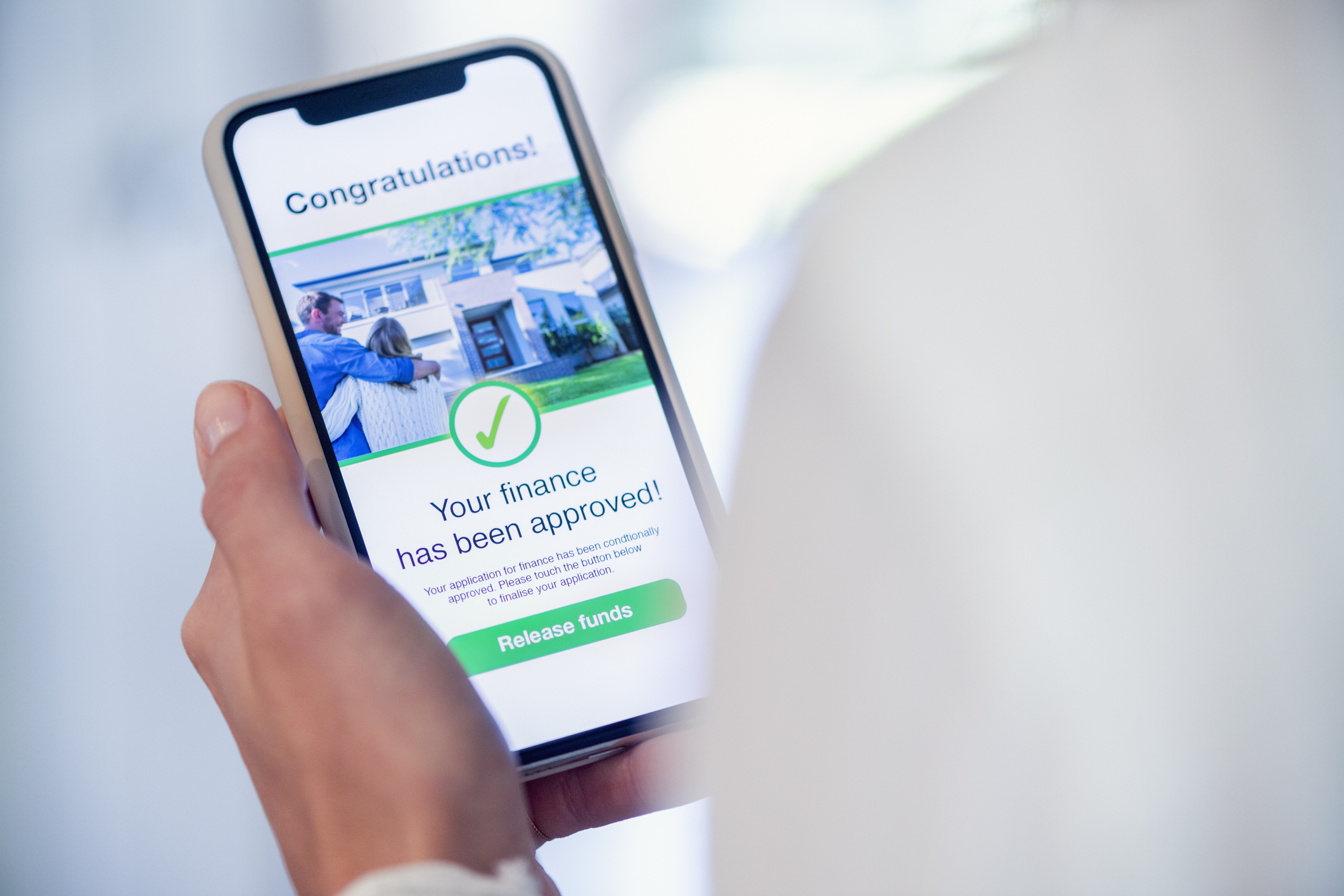 smartphone saying congratulations, your finance has been approved