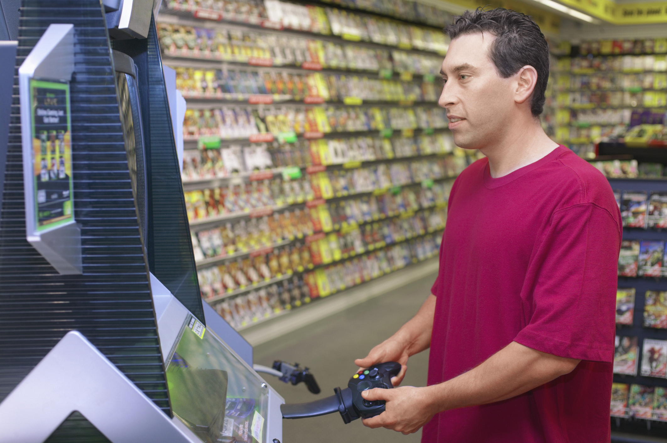 Man playing a video game in a vidoe game store