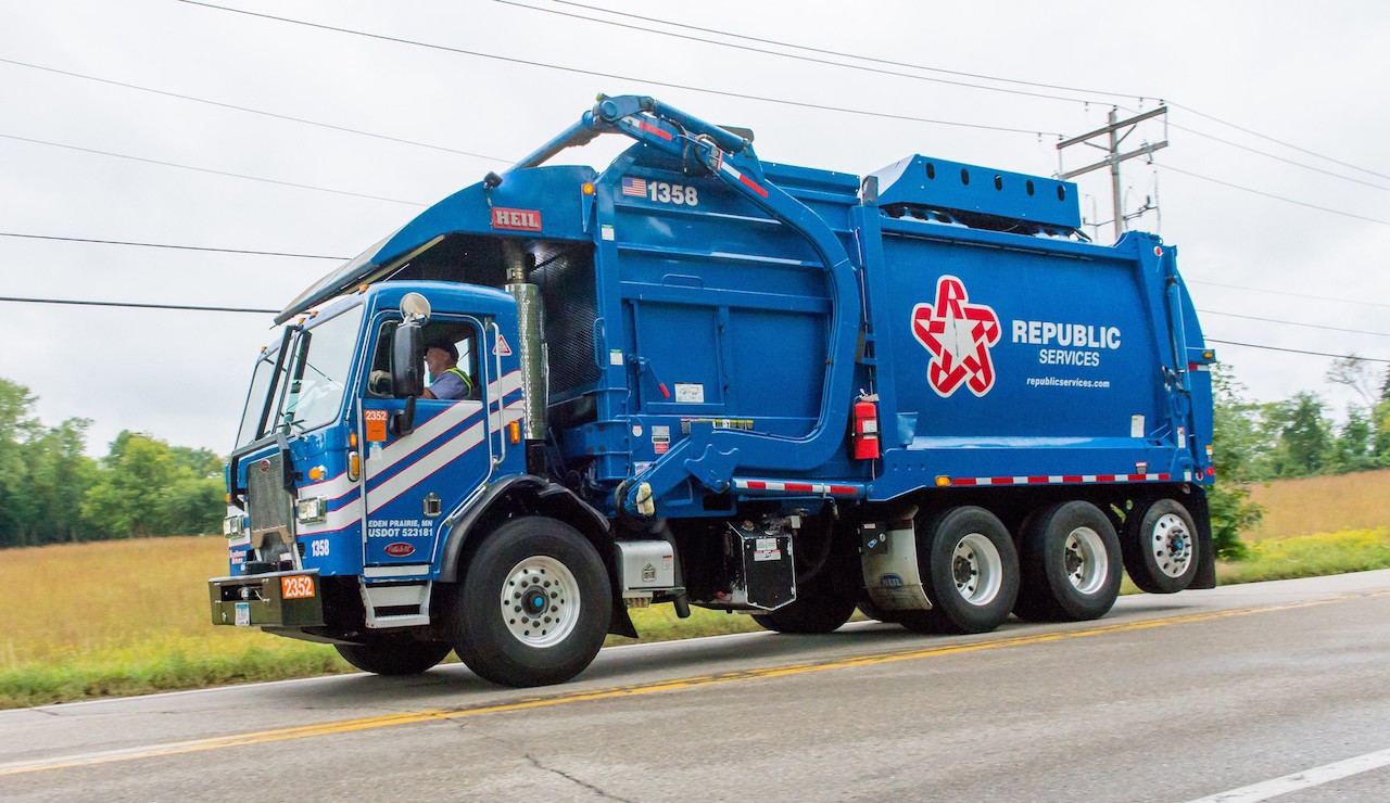 A blue Republic Services garbage truck. 