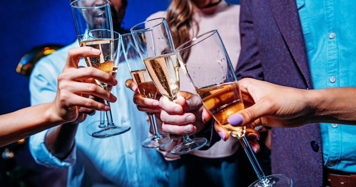 Several people clinking champagne glasses.