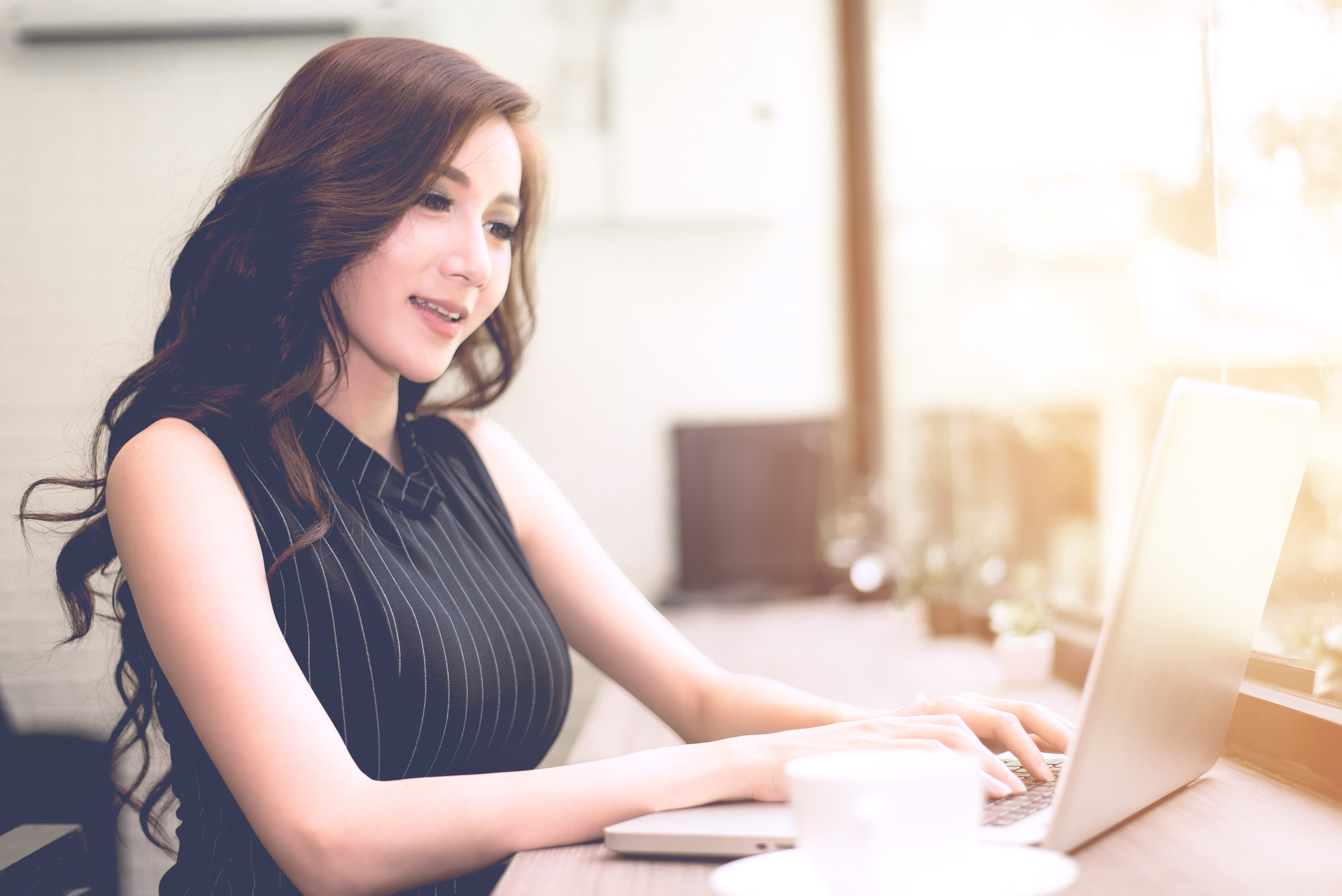 A woman using a laptop.
