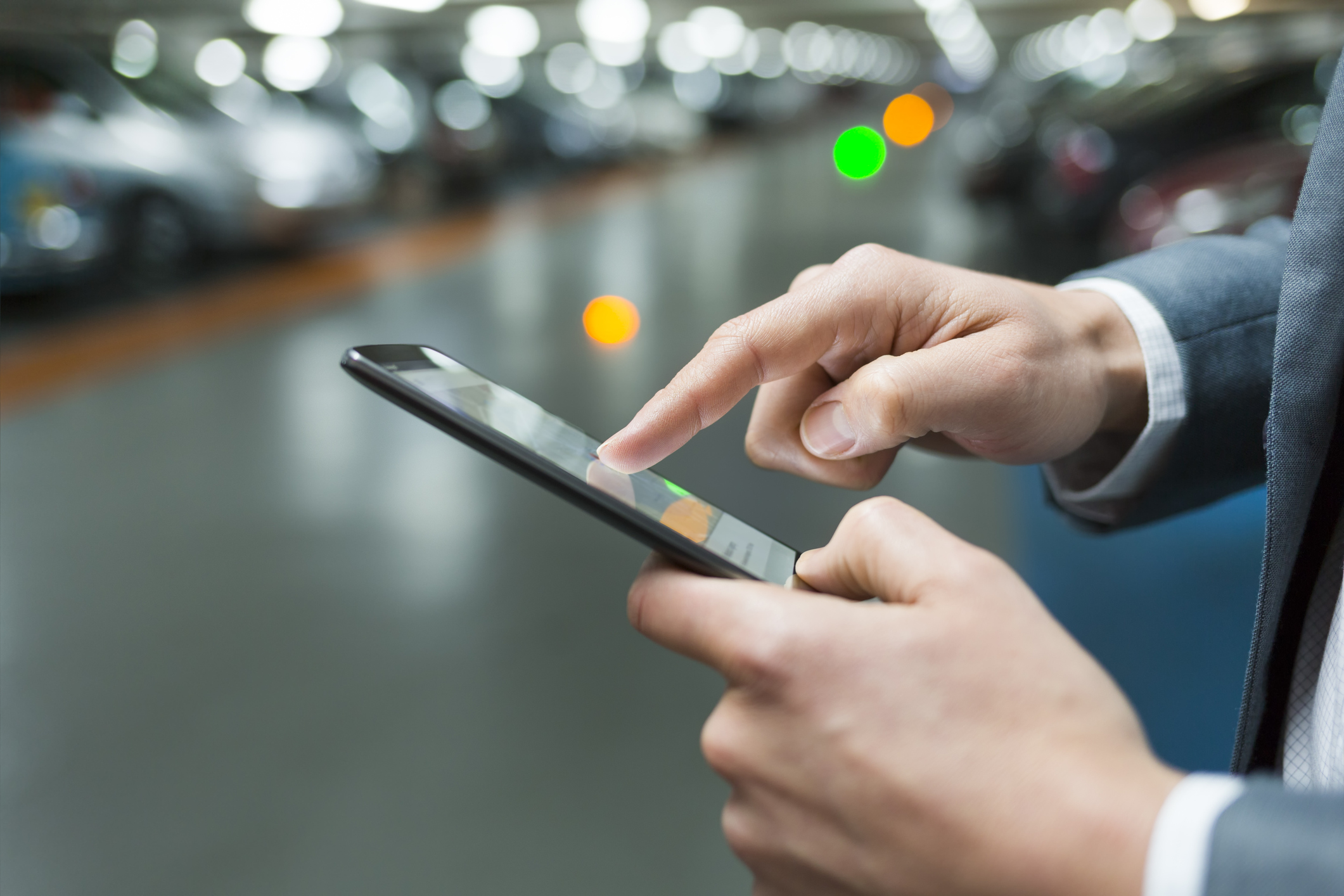 A businessman uses an app on his smartphone.