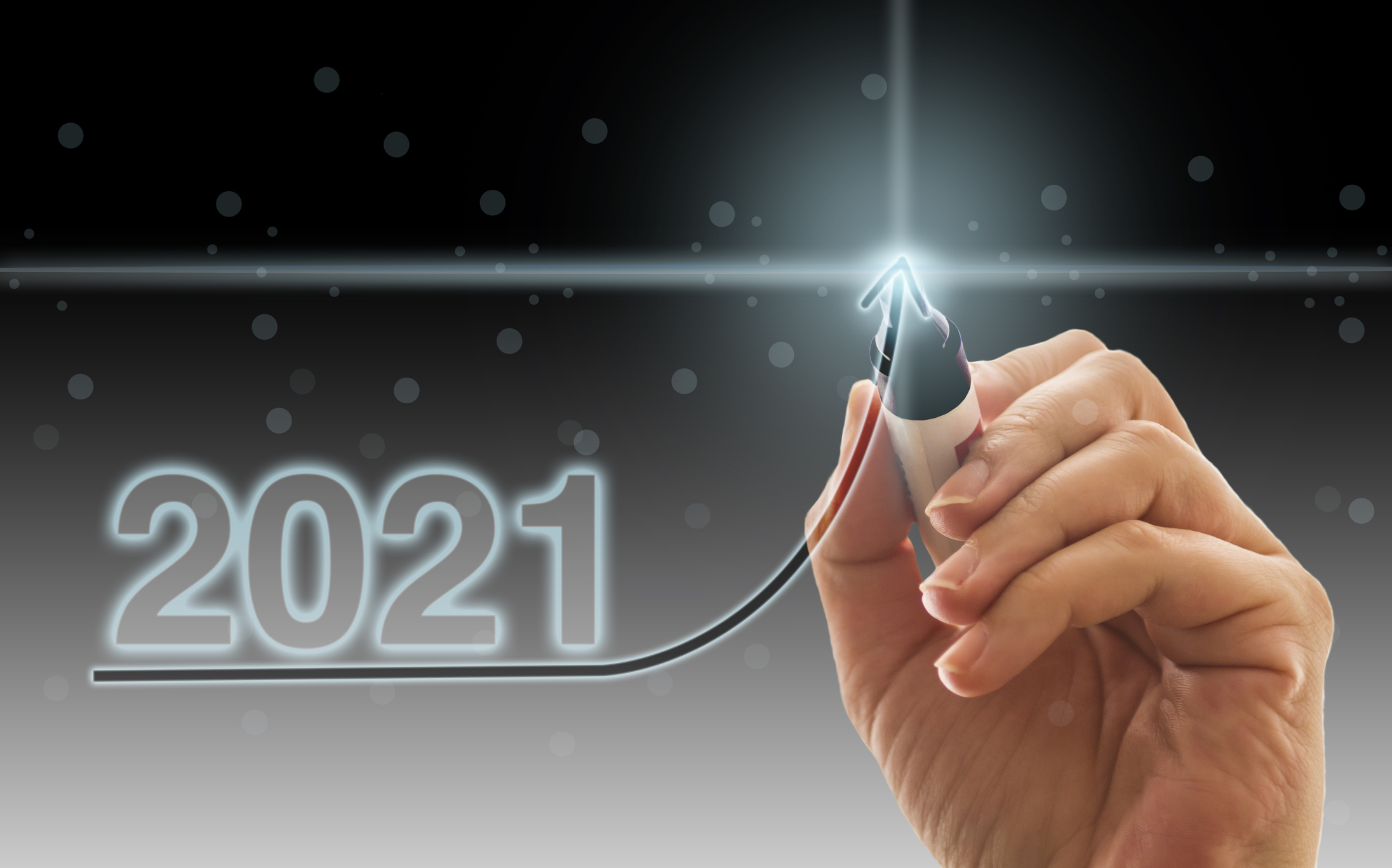 A black magic marker digitally tracing an upward arrow under the numbers 2021.