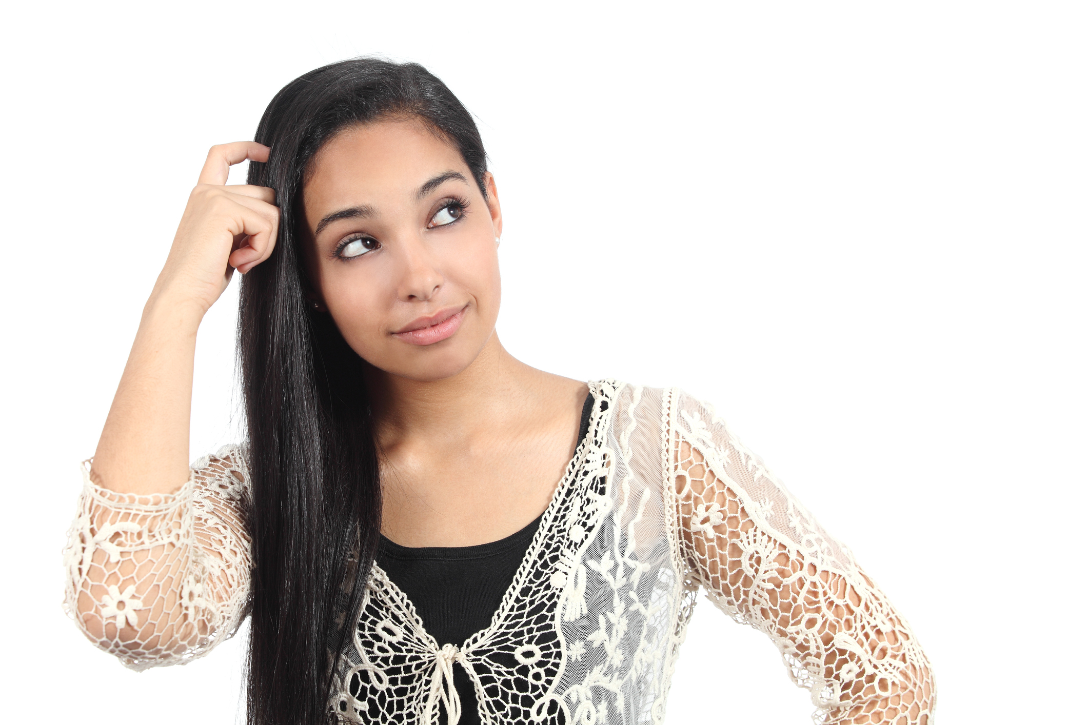 A young woman scratches her head, glancing over her shoulder.