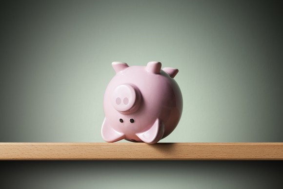 Upside down piggy bank on a shelf.
